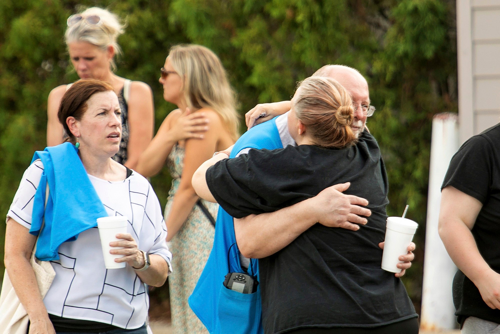 Walmart employees and customers wait outside while law enforcement investigates the scene after a stabbing incident in Traverse City, Michigan, on Saturday. Photo: Traverse City Record-Eagle/AP