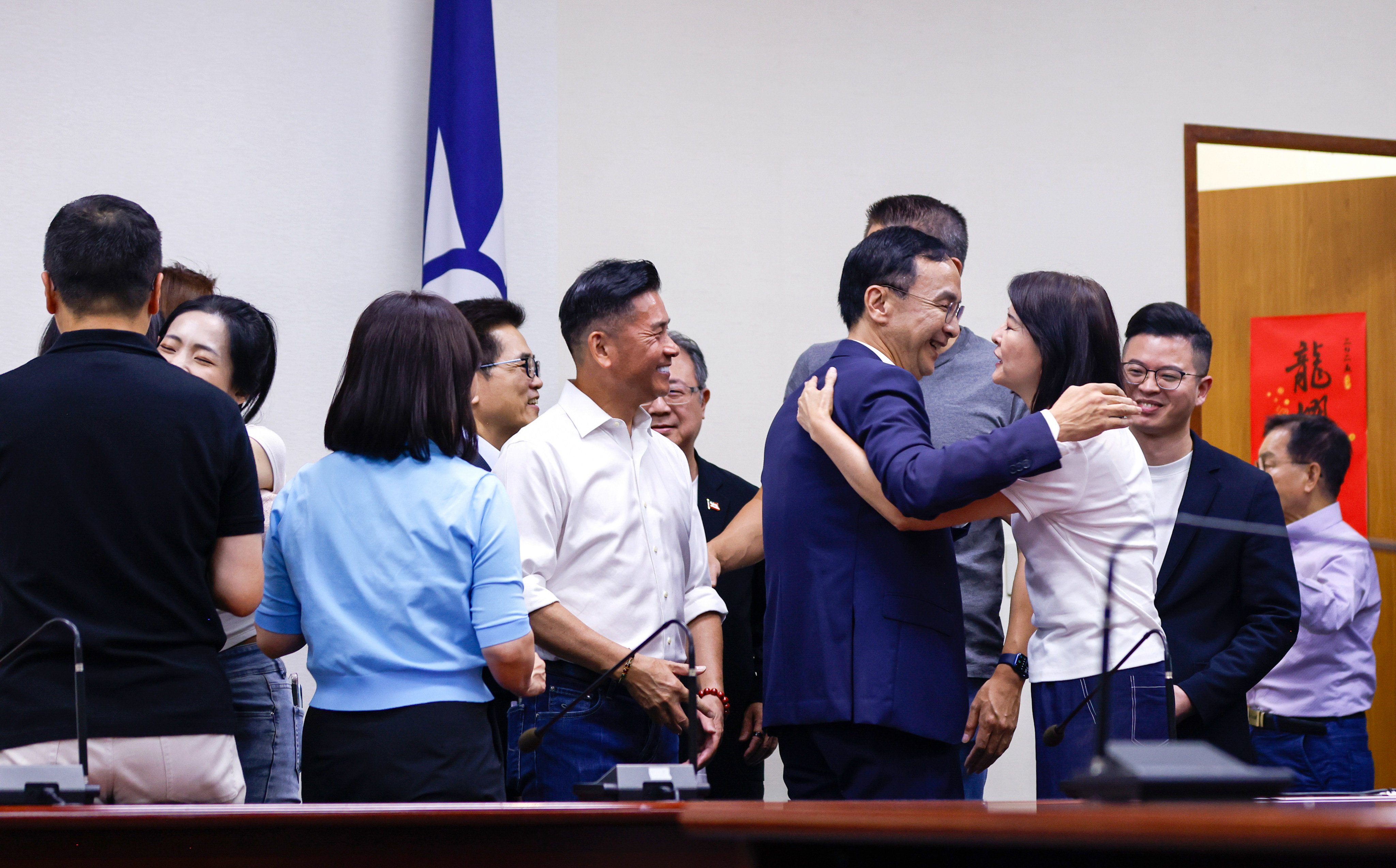 KMT leader Eric Chu celebrates the result with lawmakers, in Taipei on Saturday. Photo: EPA