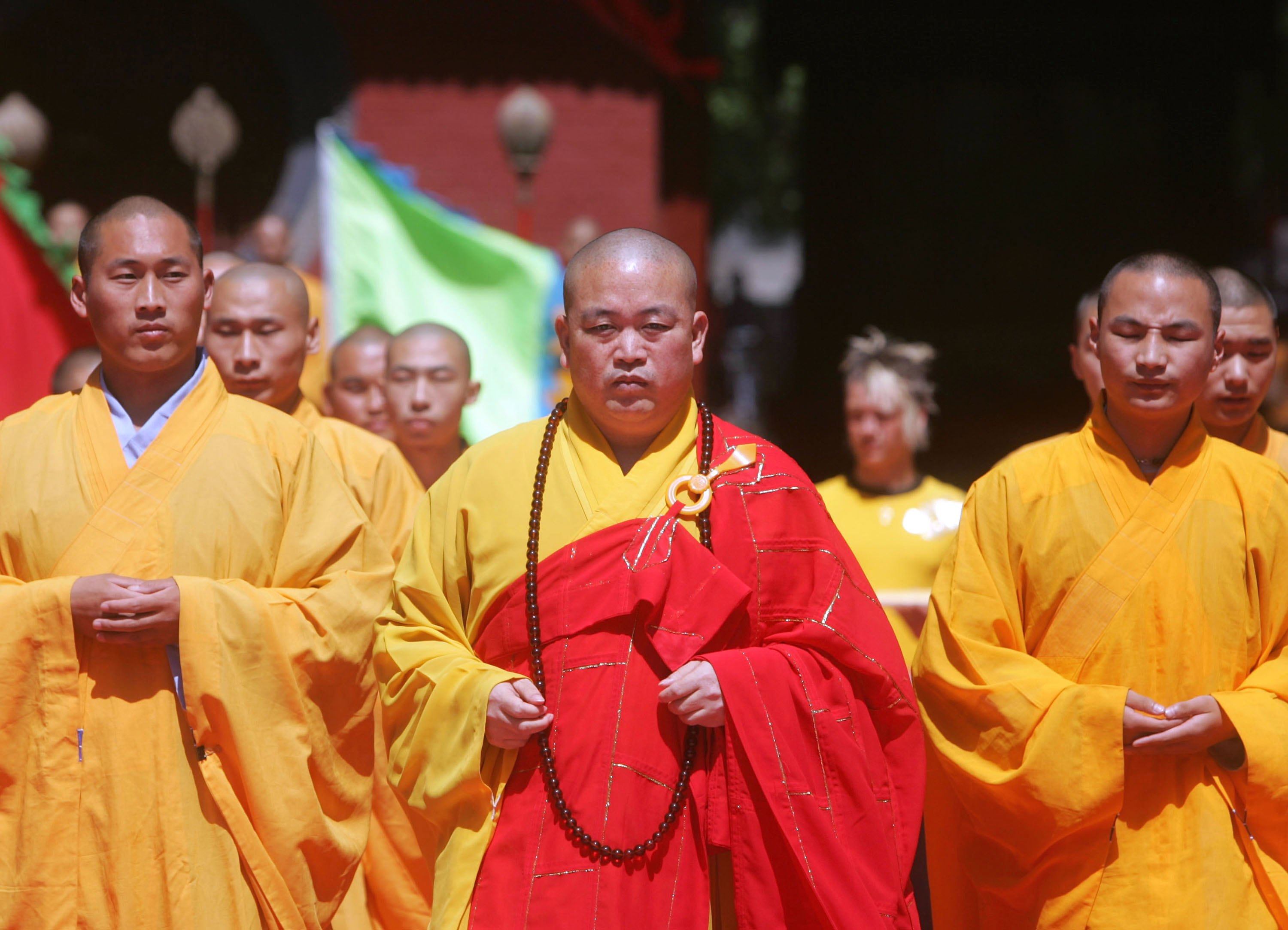 Shi Yongxin (centre), abbot of the Shaolin Temple in central China, is under joint investigation by multiple departments. Photo: Getty Images