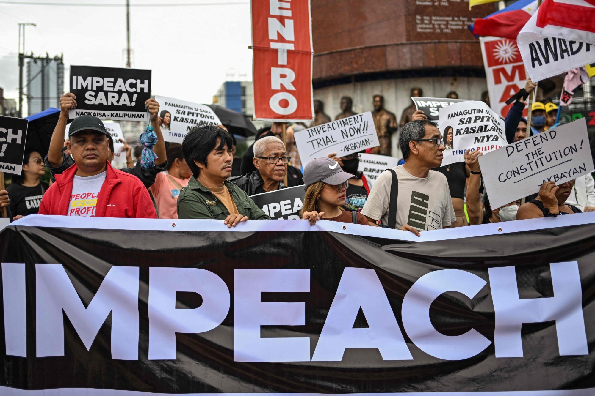 Protesters in Quezon City display placards and hold a banner calling for Philippine Vice-President Sara Duterte’s impeachment on Saturday. Photo: AFP Protesters in Quezon City display placards and hold a banner calling for Philippine Vice-President Sara Duterte’s impeachment on Saturday. Photo: AFP
