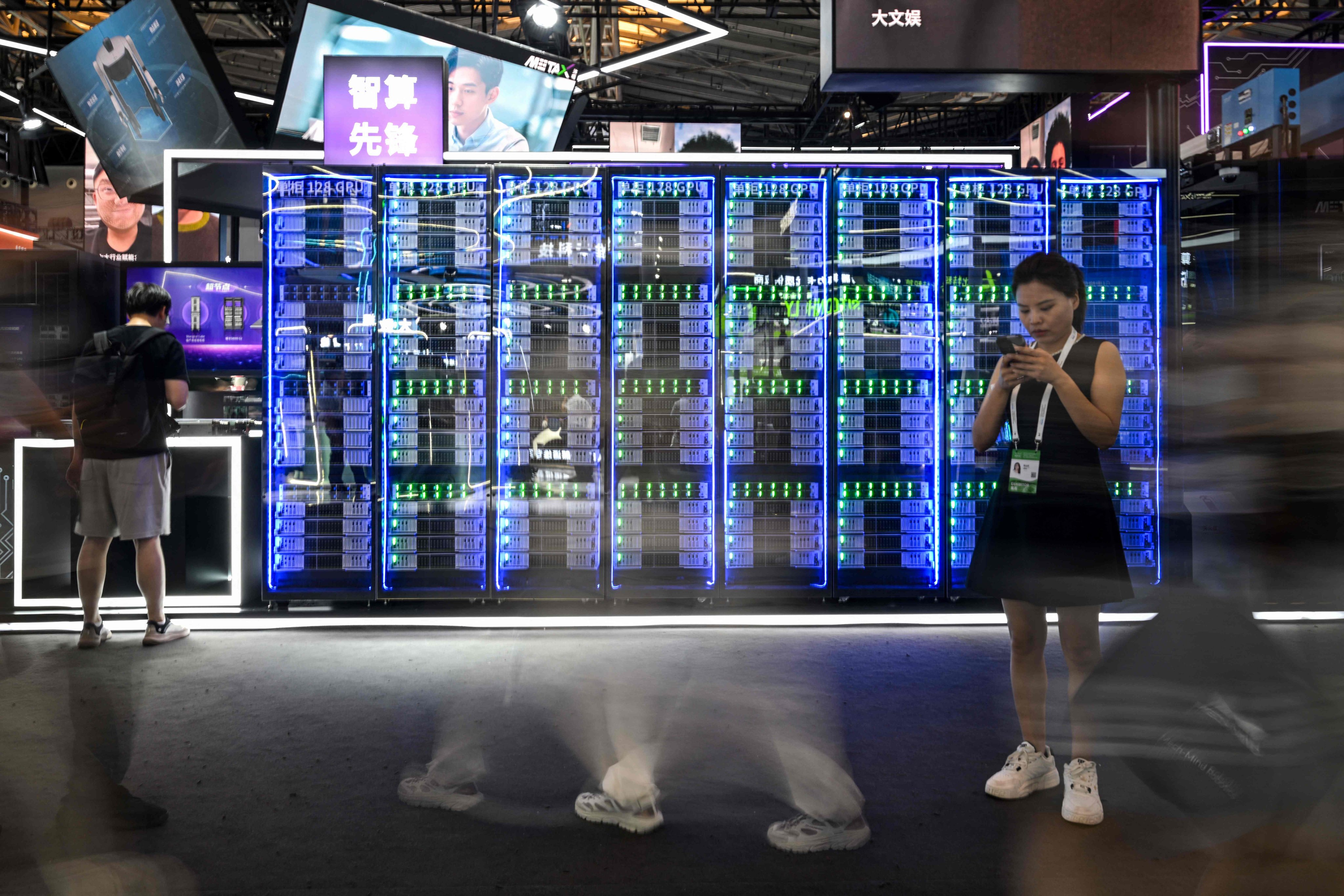 A long-exposure image shows visitors at the World Artificial Intelligence Conference in Shanghai on Monday. Photo: AFP
