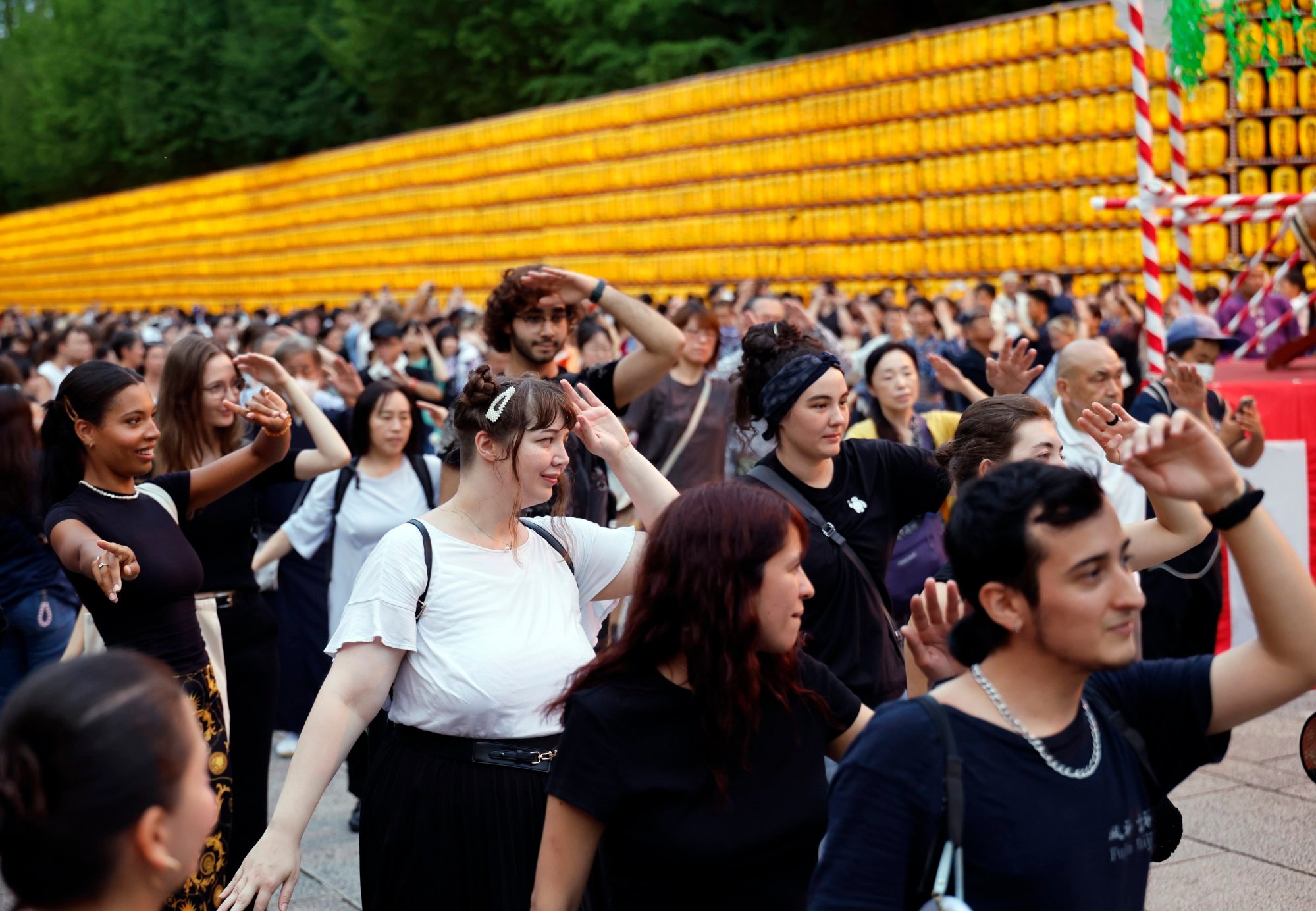 Tourists participate in a traditional Japanese folk dance at the Yasukuni Shrine during the annual Mitama Festival in Tokyo on July 16. According to the Japan National Tourism Organisation, the number of foreign visitors to Japan in June reached 3.37 million, a 7.6 per cent increase from the same month last year, marking a record high for June. Photo: EPA Tourists participate in a traditional Japanese folk dance at the Yasukuni Shrine during the annual Mitama Festival in Tokyo on July 16. According to the Japan National Tourism Organisation, the number of foreign visitors to Japan in June reached 3.37 million, a 7.6 per cent increase from the same month last year, marking a record high for June. Photo: EPA