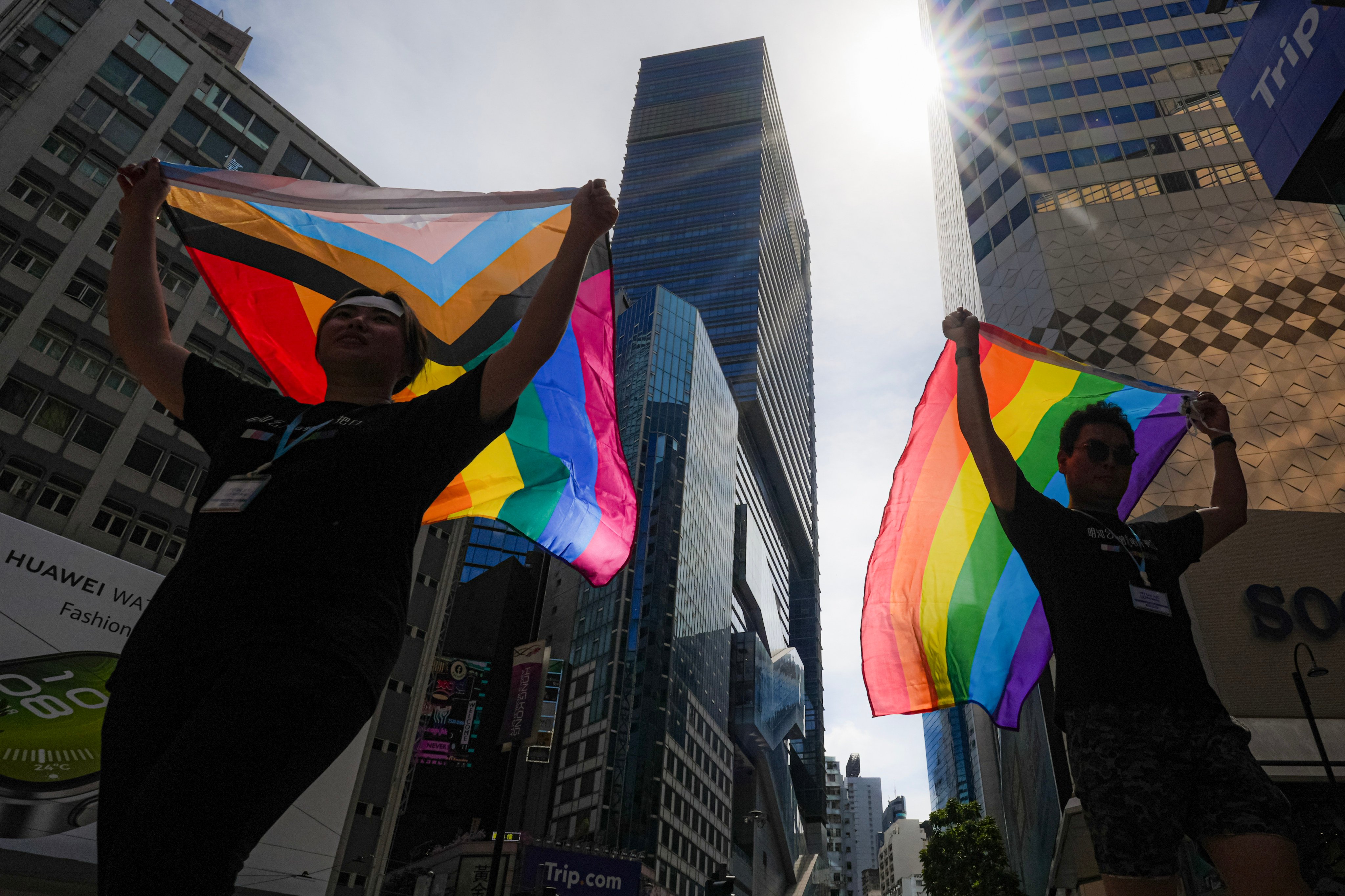 Two people pose for a photo with pride flags in Causeway Bay as they hold promotional booths on International Day Against Homophobia, Biphobia and Transphobia on May 17. Photo: Eugene Lee