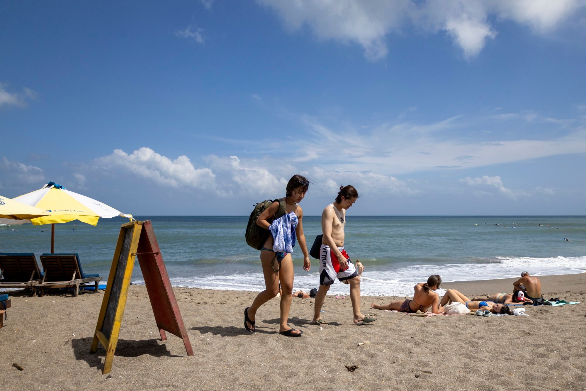 Tourists spend time at a beach in Canggu, Bali, Indonesia, earlier in July. Bali officials say the island can still accommodate an influx of visitors. Photo: EPA Tourists spend time at a beach in Canggu, Bali, Indonesia, earlier in July. Bali officials say the island can still accommodate an influx of visitors. Photo: EPA