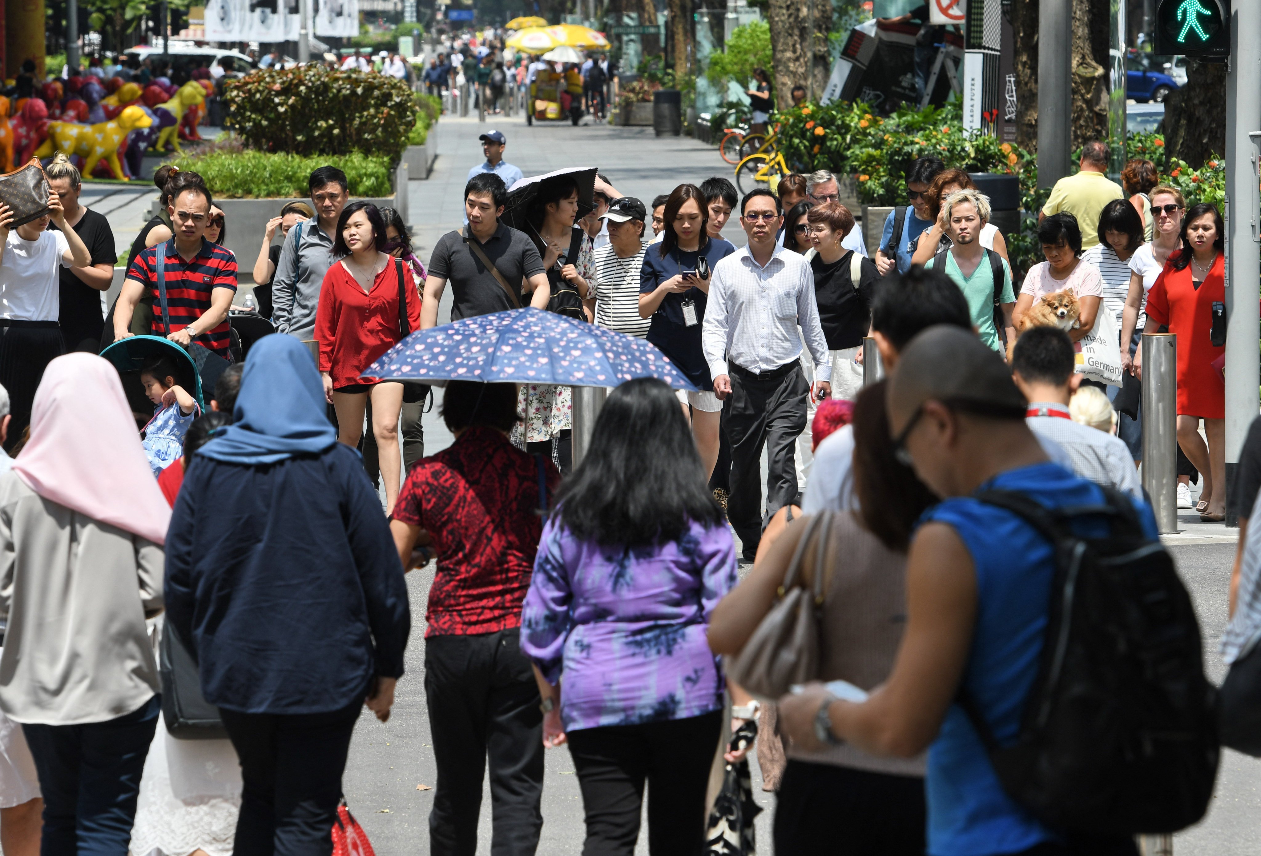 People walking along Orchard Road. A survey was conducted last year to assess the responses of Singaporeans of different ethnicities on the idea of “Chinese privilege”. Photo: AFP