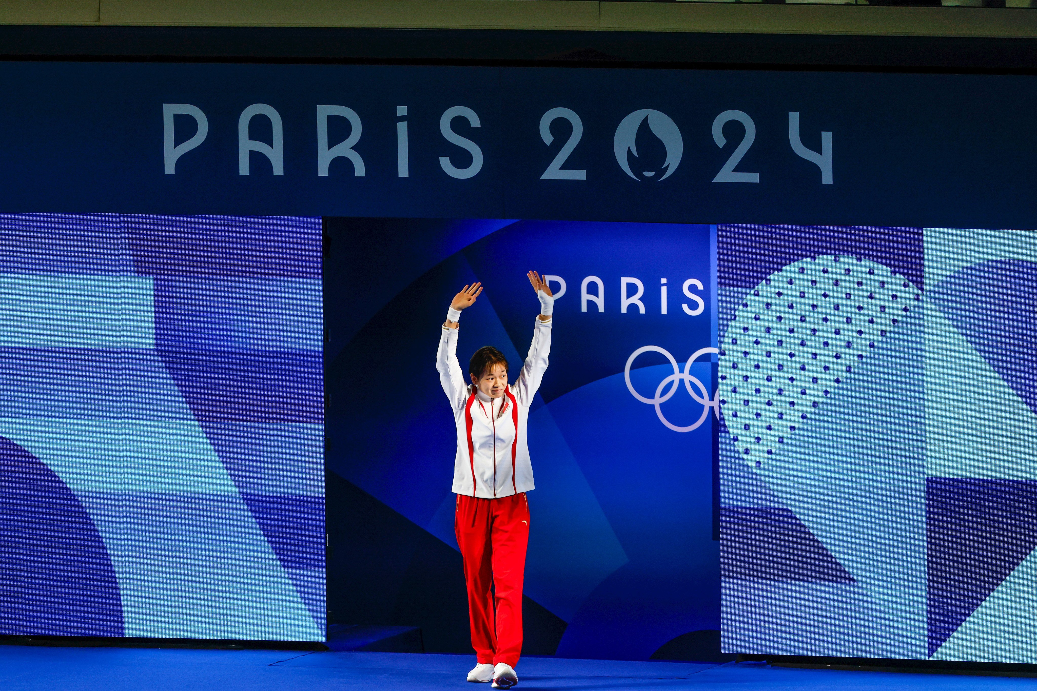 Quan Hongchan waves to the crowd ahead of the  women’s 10m platform final at the Aquatics Centre in Paris. Photo: Getty Images