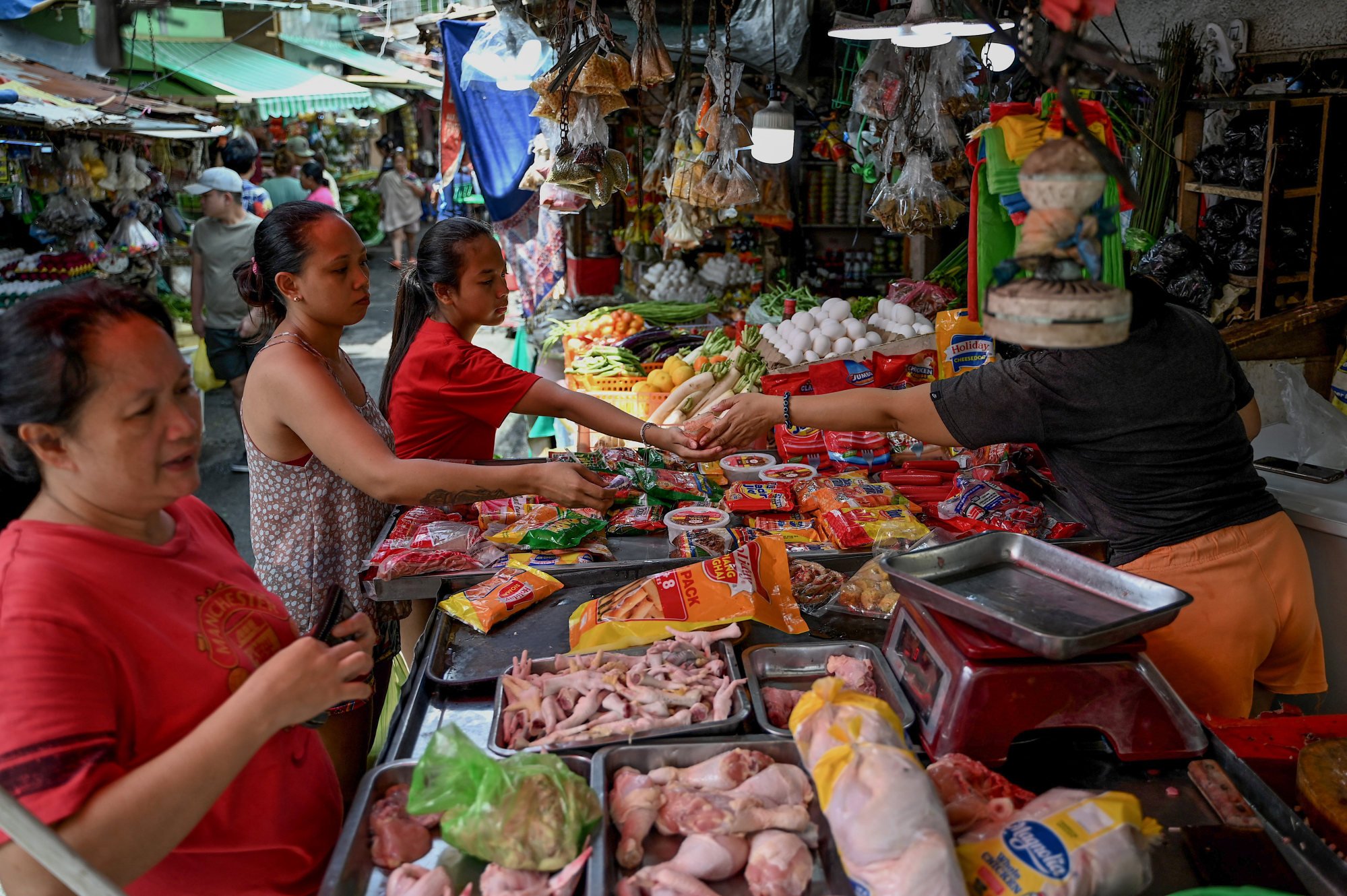 Women shop at a market in Manila in 2023. Food is becoming increasingly unaffordable for regular Filipinos, analysts say. Photo: AFP