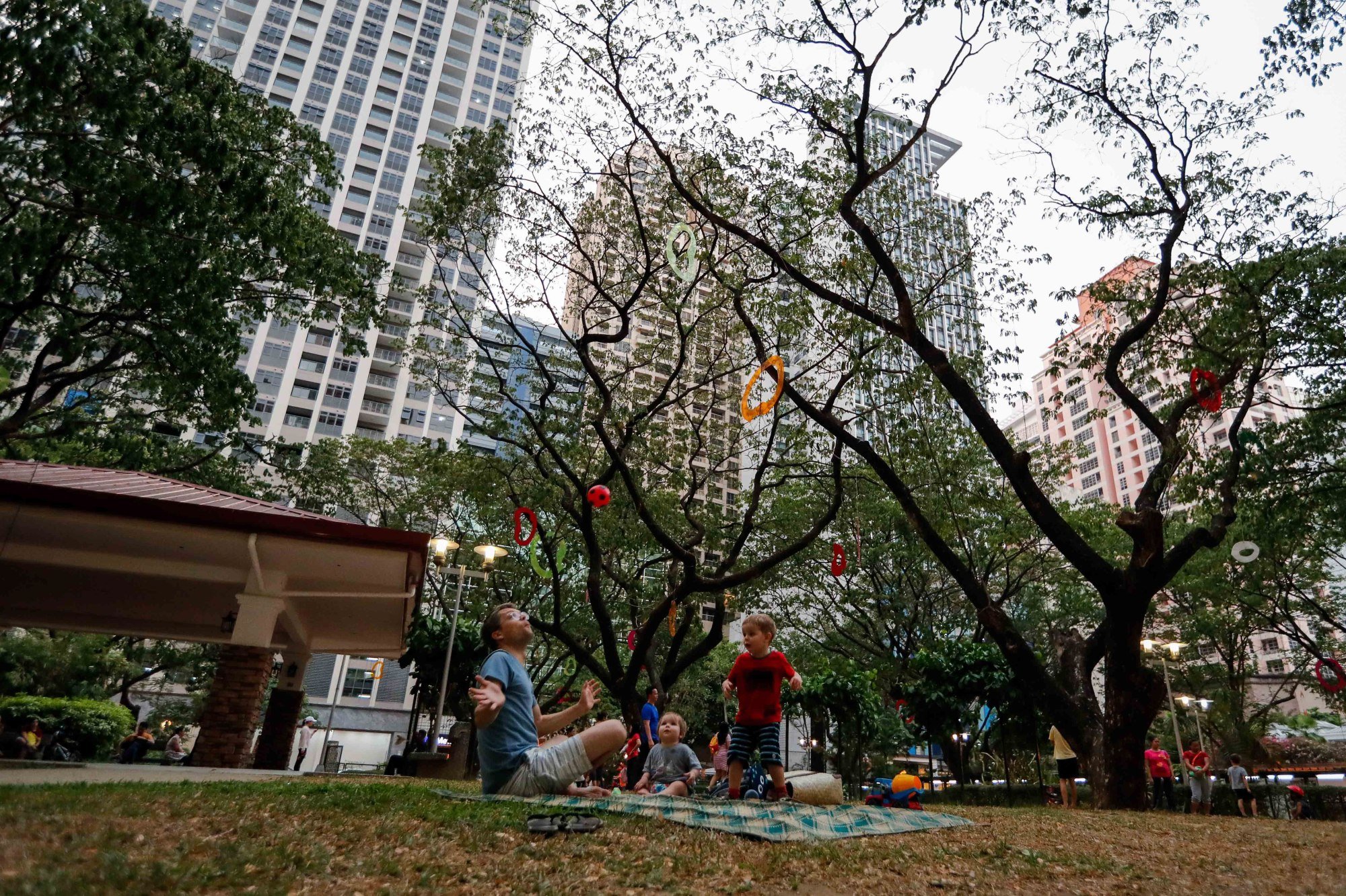 A family plays with a ball at a pocket park on private land in Makati, south of Manila, in 2019. Marcos urged local governments to revitalise public parks and plazas. Photo: EPA-EFE