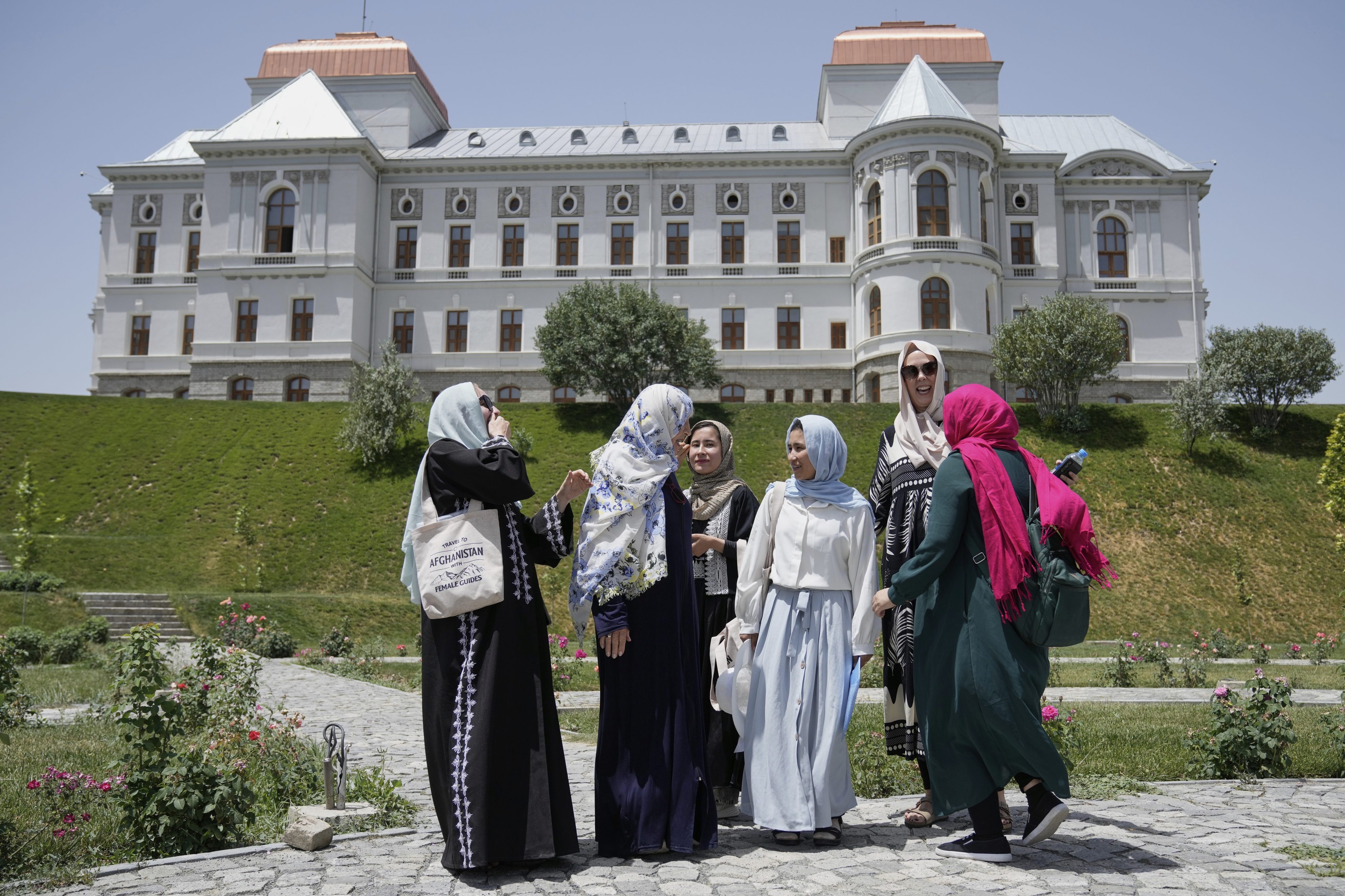 Three foreign tourists visit Darul Aman Palace accompanied by three female tour guides in Kabul, Afghanistan, on May 28. Photo: AP