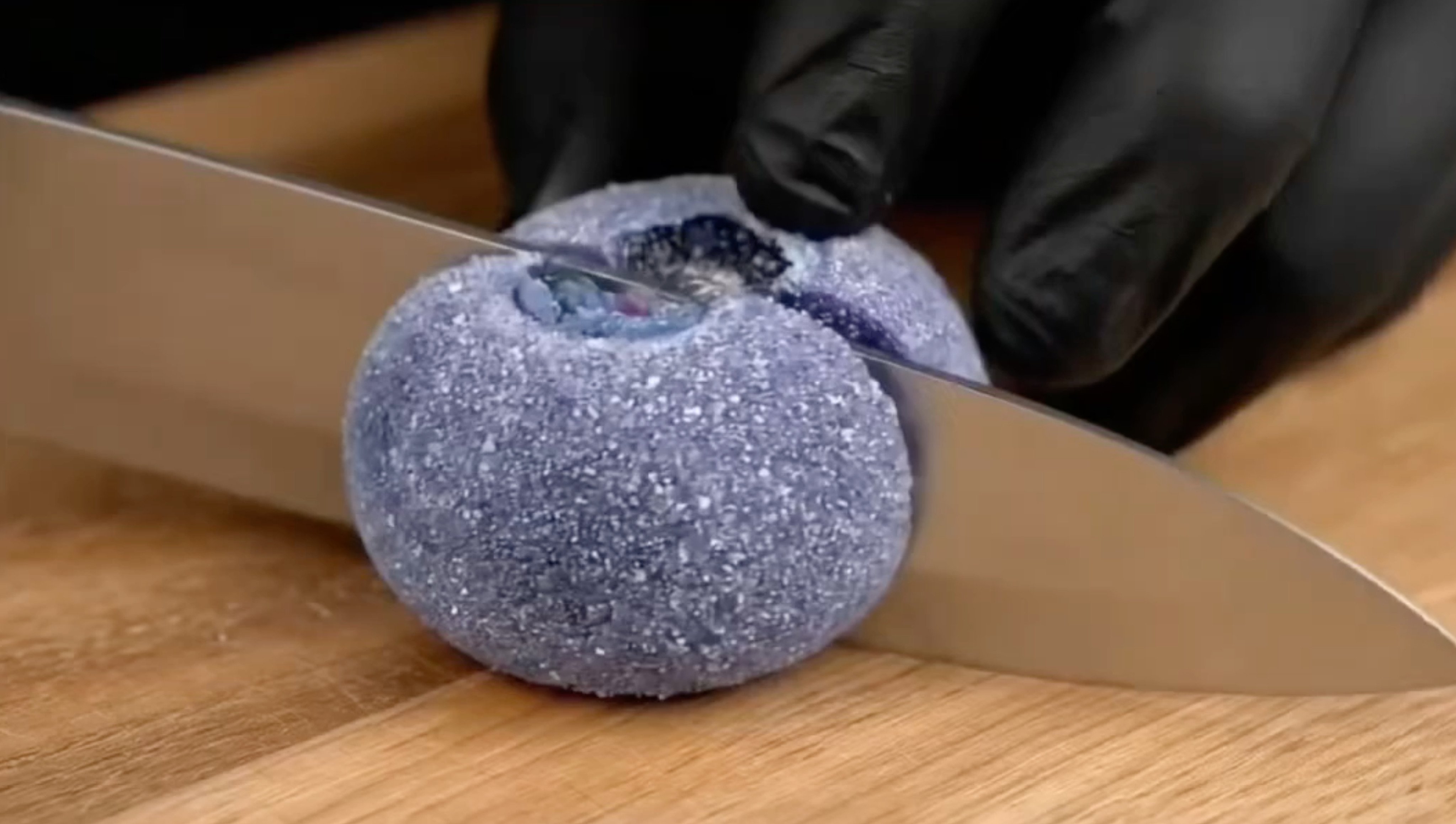 A still from an AI ASMR video showing someone slicing sugared blueberries. The video, which also shows other fruit being cut up, was posted in July by RedNote user Yu Mu and has received more than 7,000 likes. Photo: Rednote/ Healing Lab