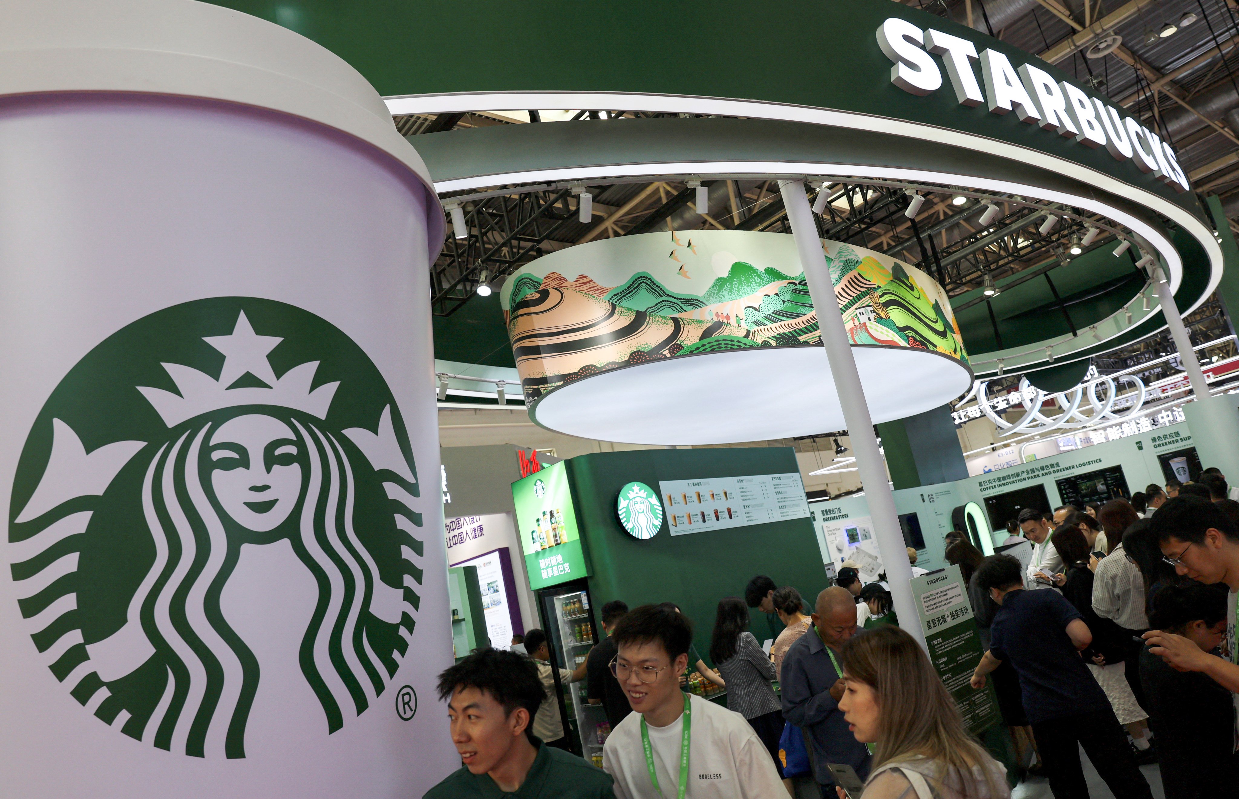 People visit the Starbucks booth during the China International Supply Chain Expo in Beijing this month. Photo: Reuters