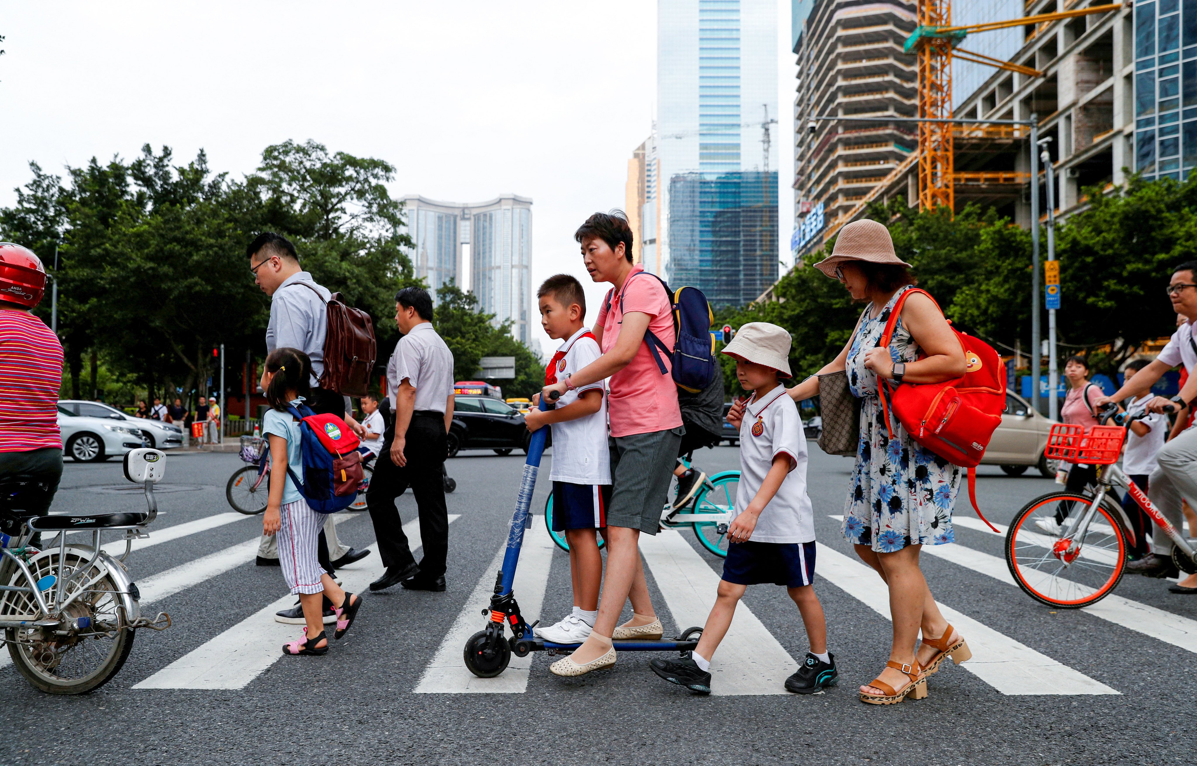 Children and their parents head to school in Guangdong province. The IMF now expects China’s economy to grow by 4.8 per cent this year. Photo: Reuters