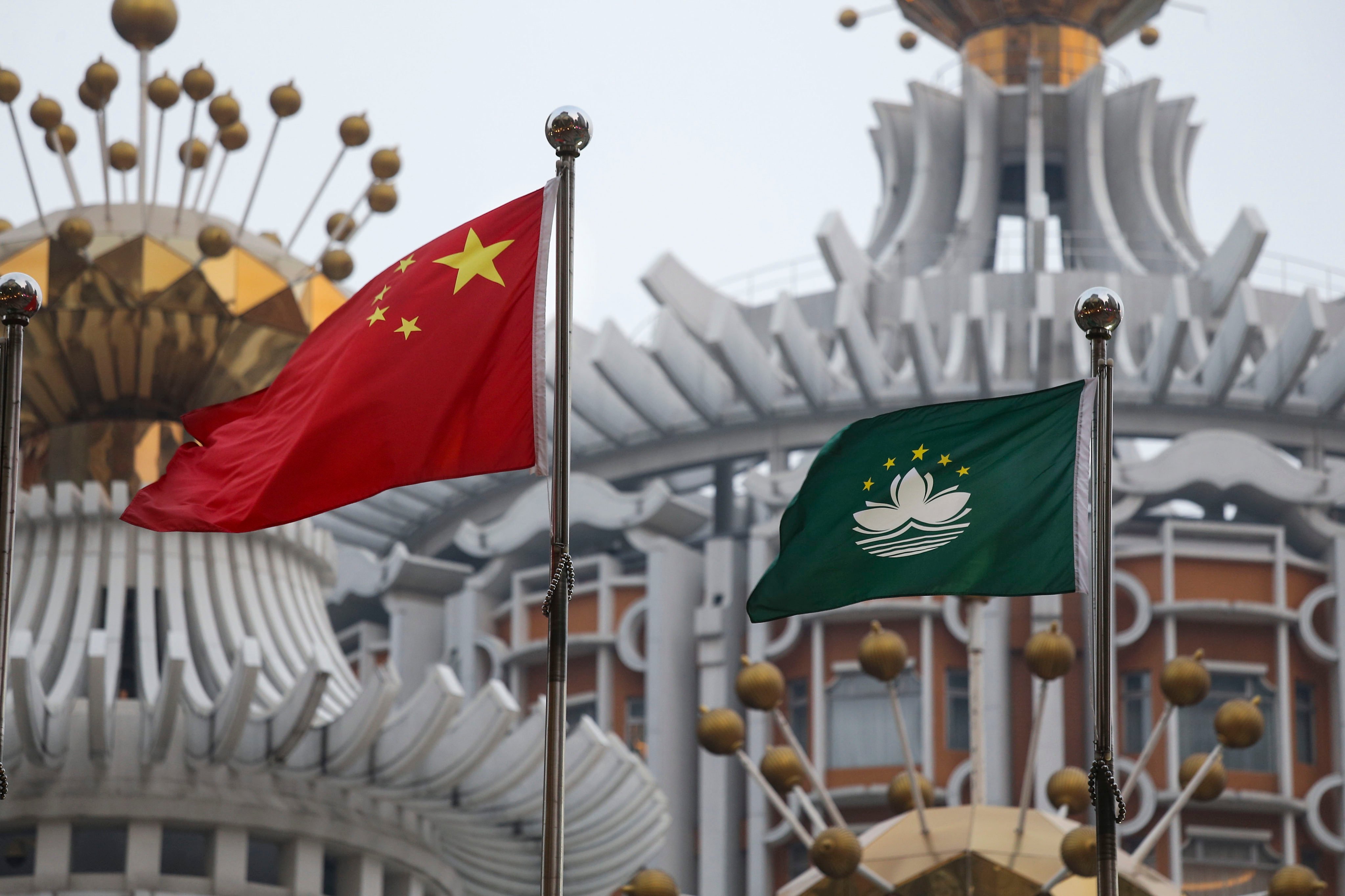 The Chinese national flag and Macau flag hoisted outside a building in Macau. Photo: Dickson Lee