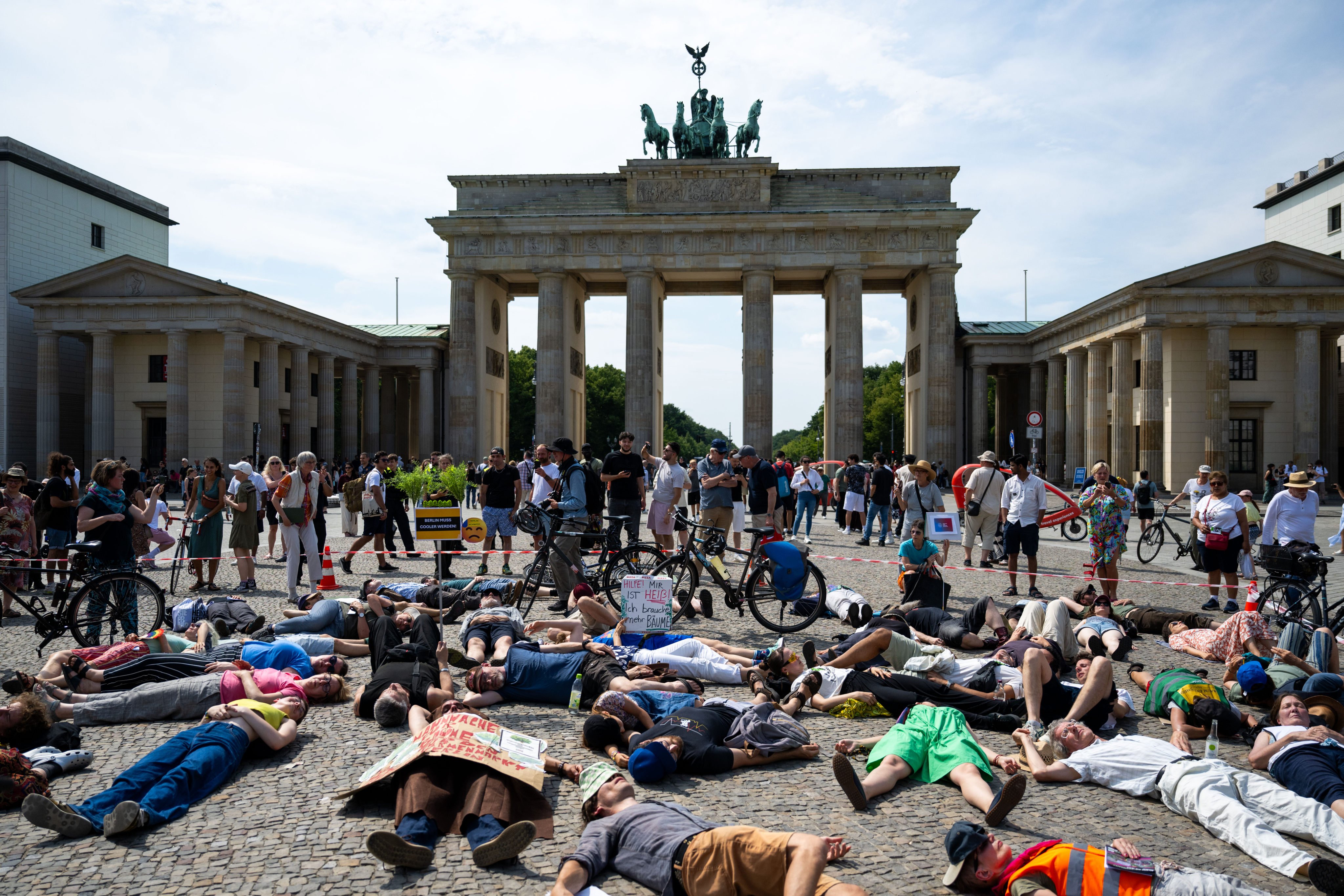 Participants lie on the ground on Berlin’s Pariser Platz and simulate death during a demonstration on July 20 to push for heat-protection laws in the city. Photo: dpa
