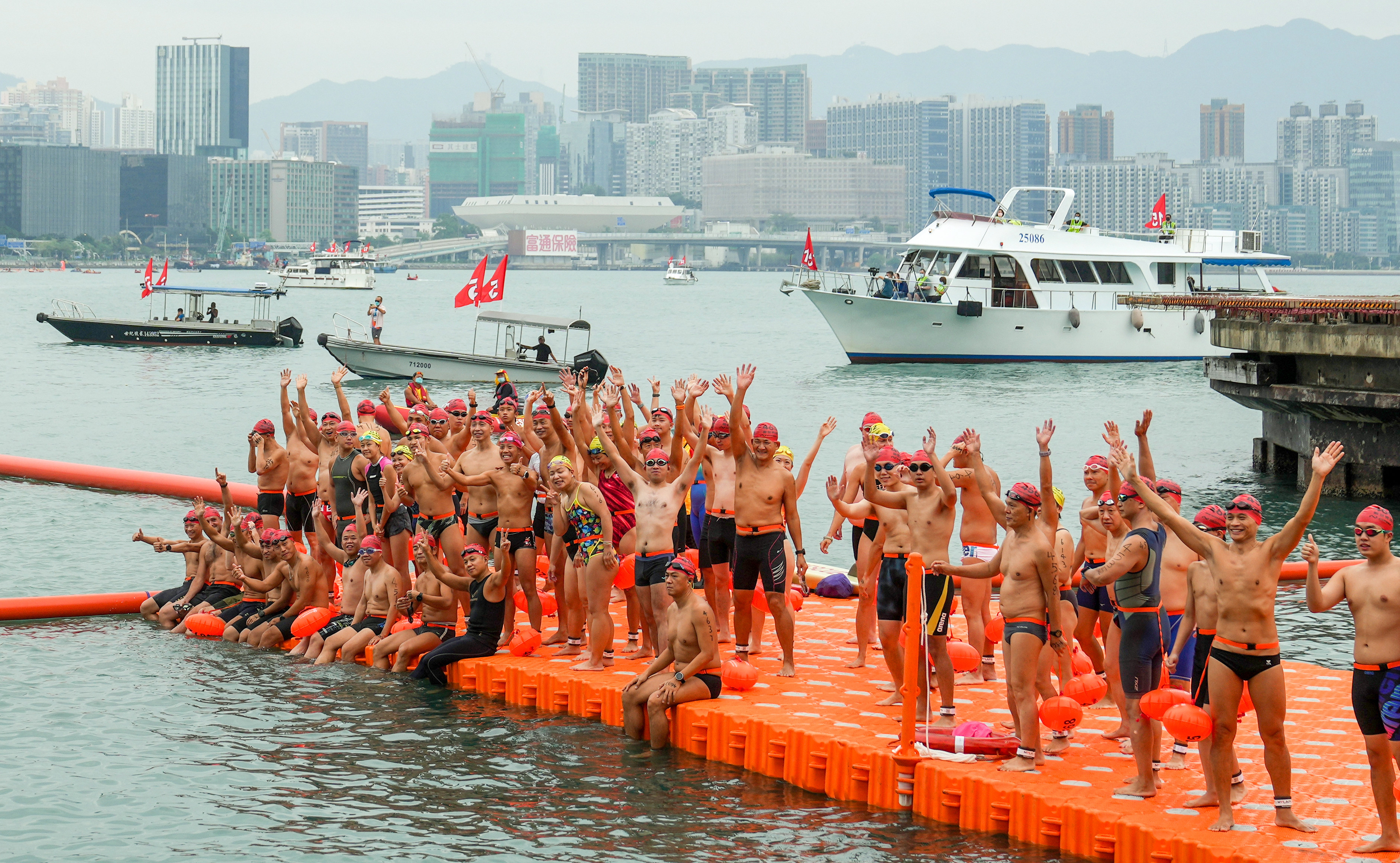 Swimmers line up at the starting point for the 2022 New World Harbour Race at Golden Bauhinia Square in Wan Chai. Photo: Sam Tsang