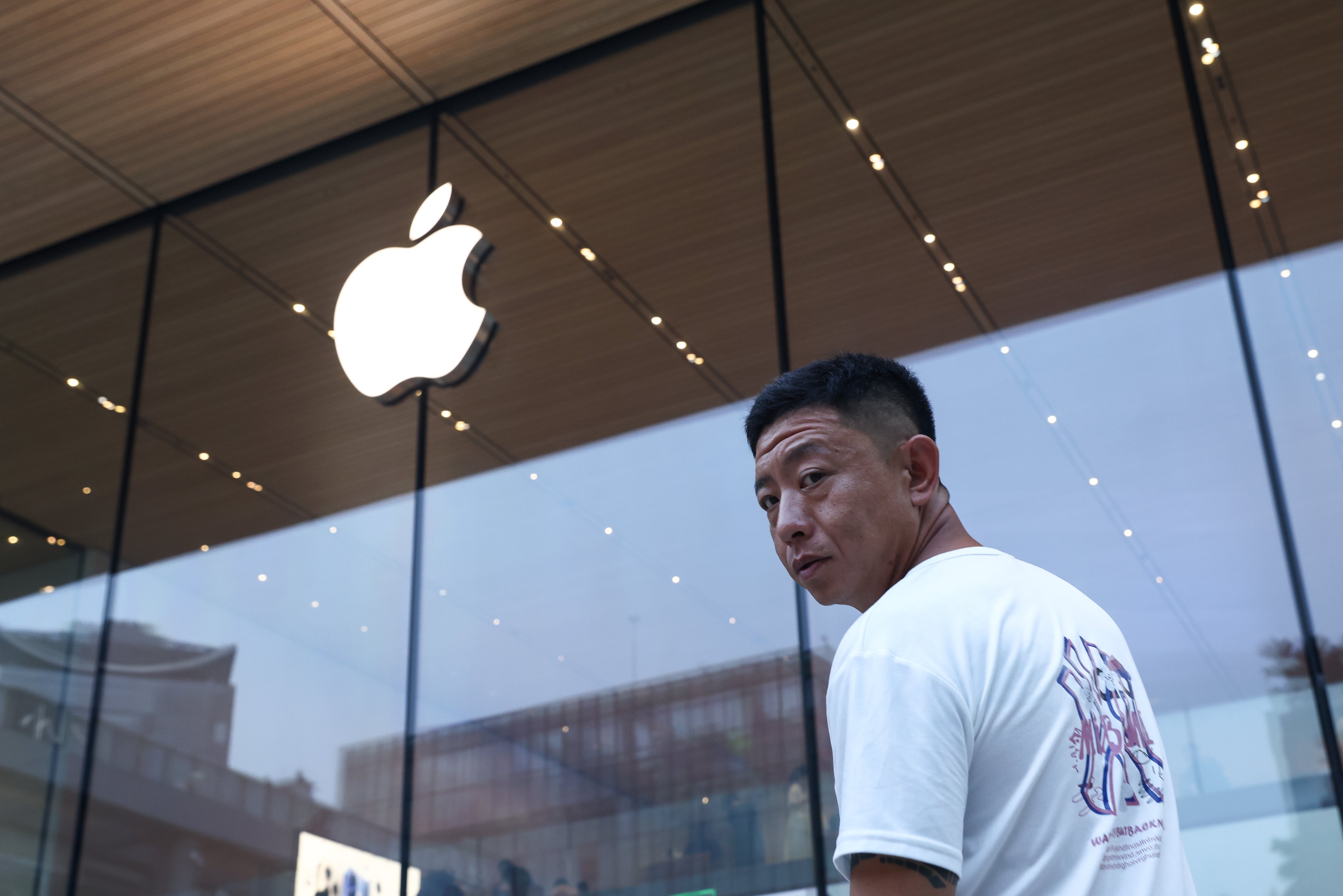 A man walks past an Apple store in Beijing. Photo: EPA