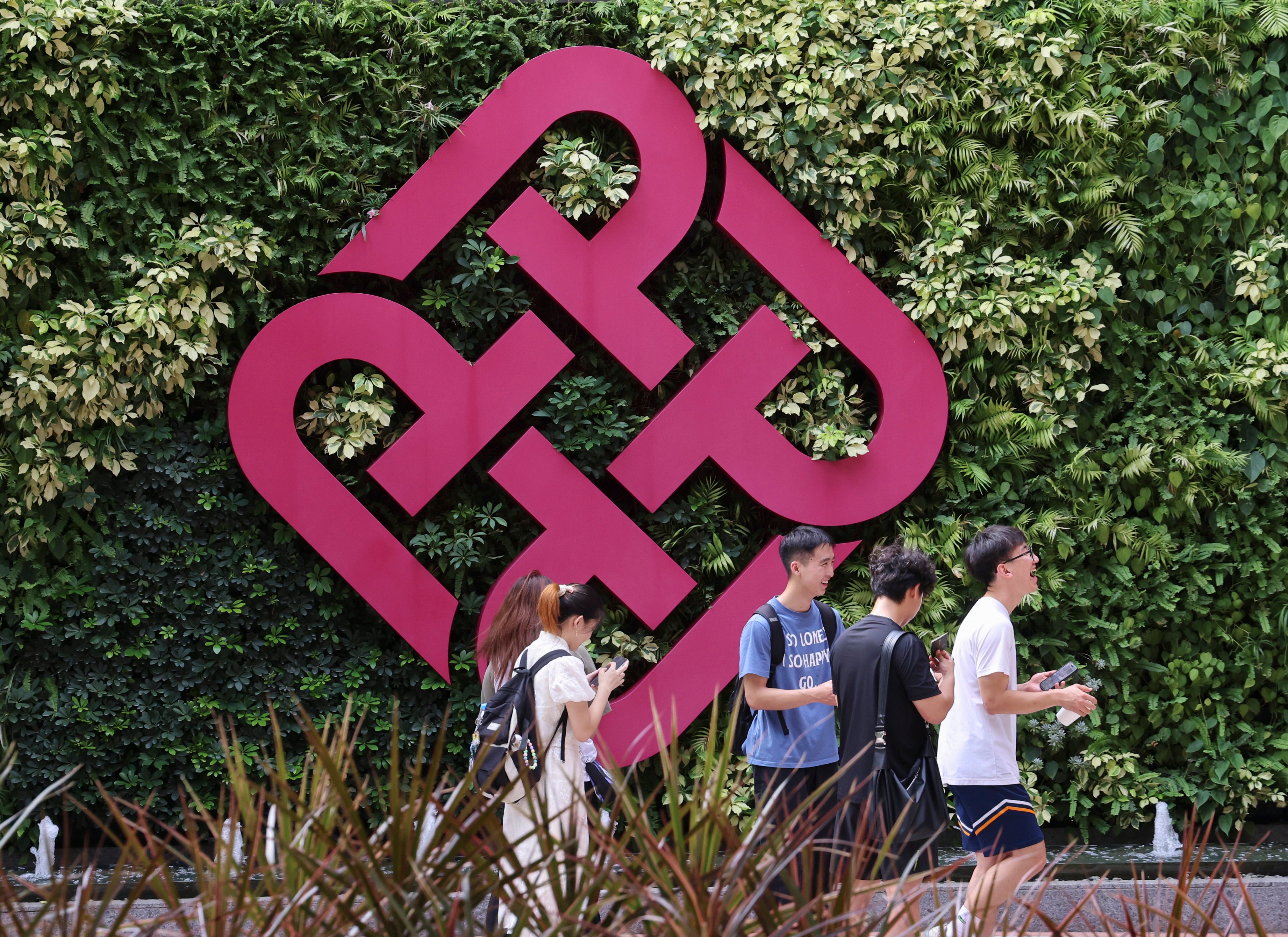 Students walking through Polytechnic University in Hung Hom on July 31. Children of non-local talent will be required to reside in Hong Kong for at least two years to become eligible for local students’ benefits at publicly funded tertiary education institutions starting in the 2027-28 academic year, as part of the government’s efforts to prevent abuse. Photo: Jelly Tse