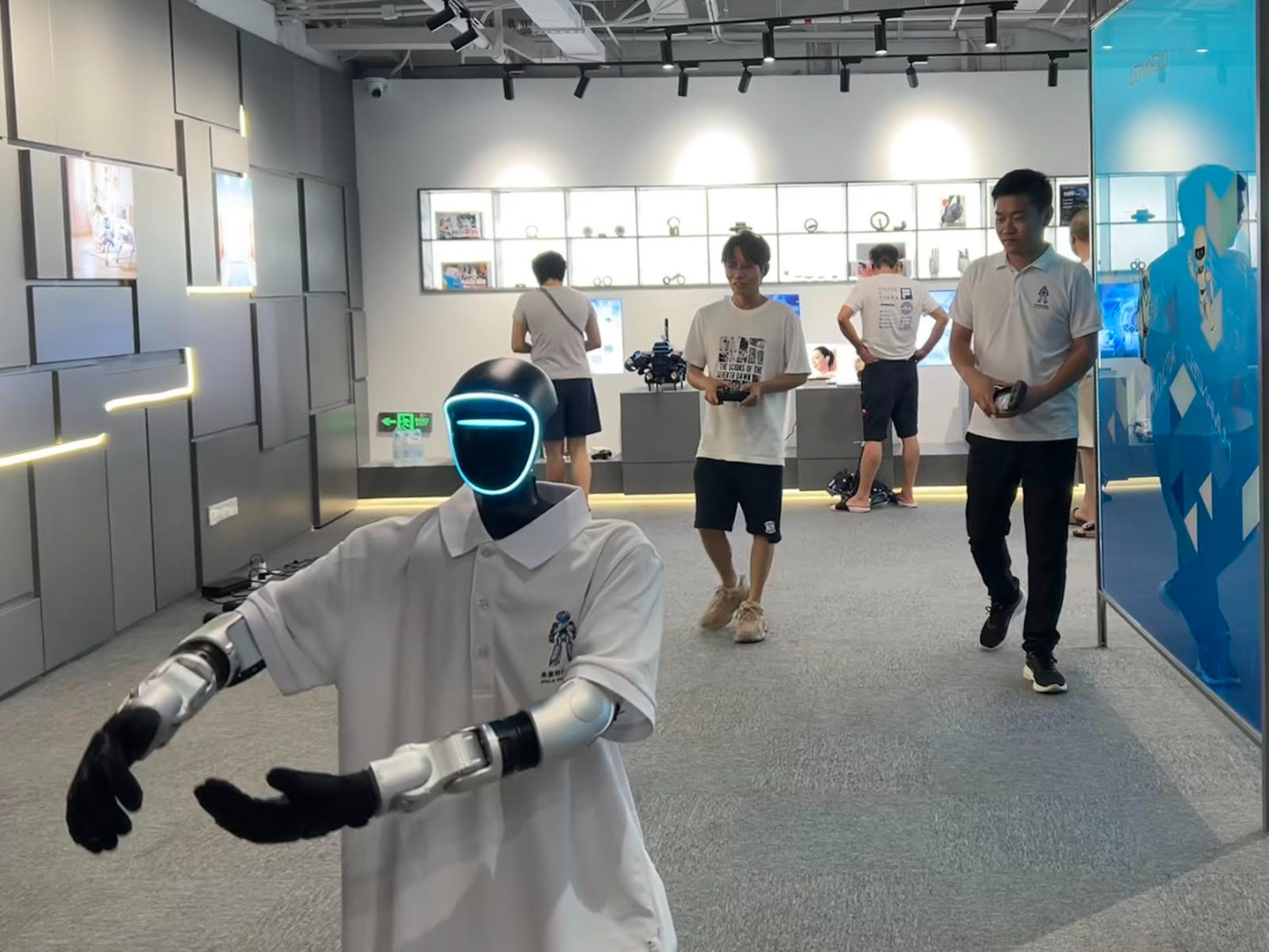 Deputy manager Zhang Shuai puts a humanoid robot through its paces with a tai chi demonstration at the Future Era store in Shenzhen on Wednesday. Photo: Alice Li