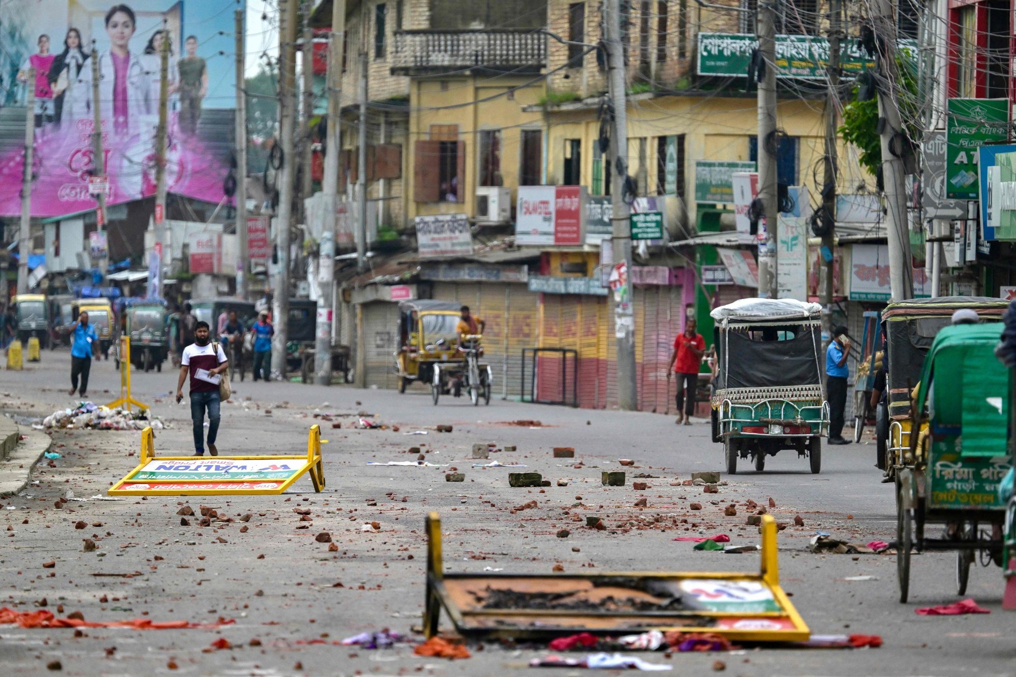 Barricades and brickbats lie scattered on the road in Gopalganj on July 17, a day after the clashes broke out between supporters of the Awami League party and police during a rally by the National Citizen Party. Photo: AFP