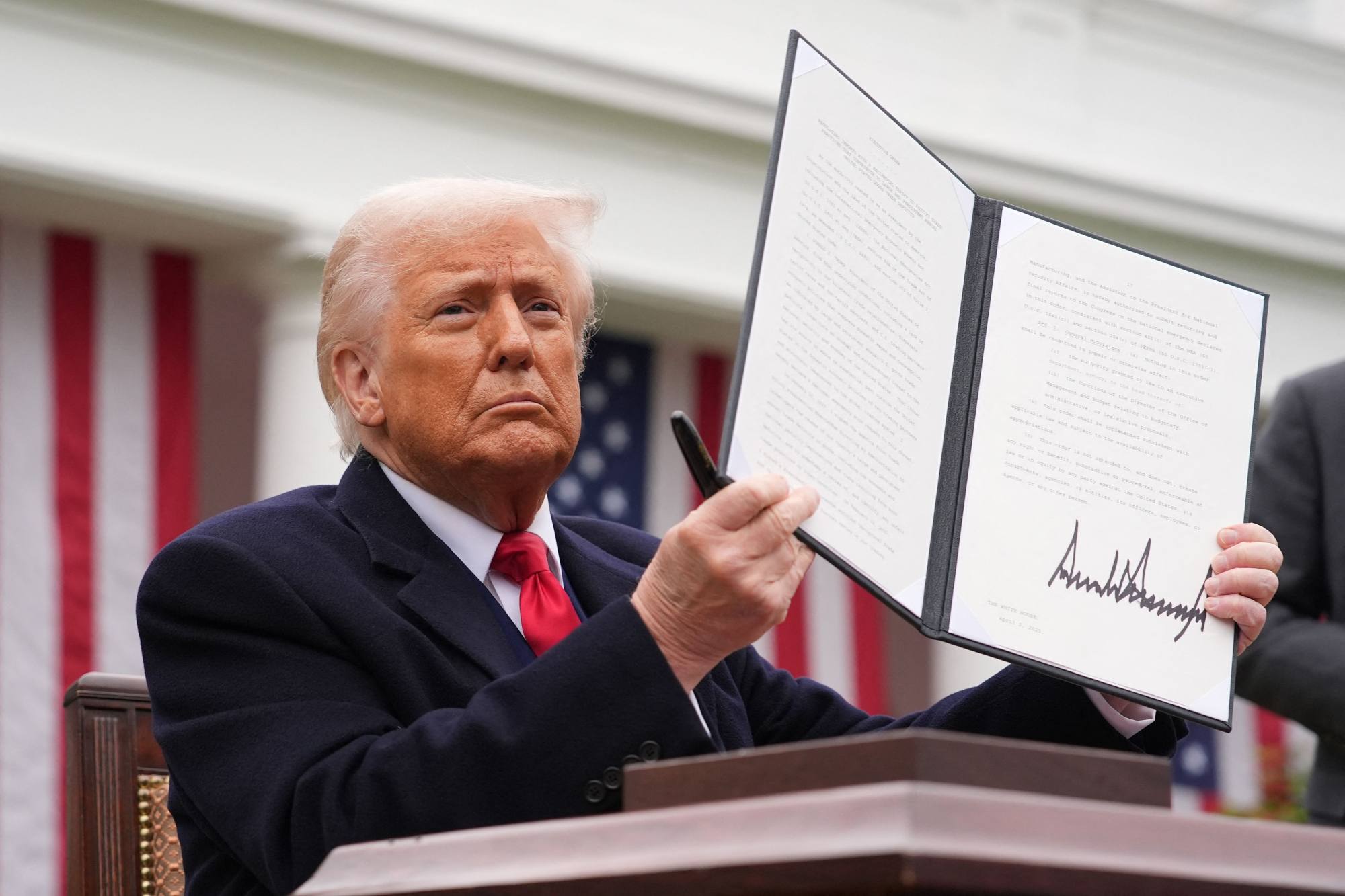 US President Donald Trump displays a signed executive order imposing tariffs on imported goods at the White House on April 2. Photo: AFP US President Donald Trump displays a signed executive order imposing tariffs on imported goods at the White House on April 2. Photo: AFP