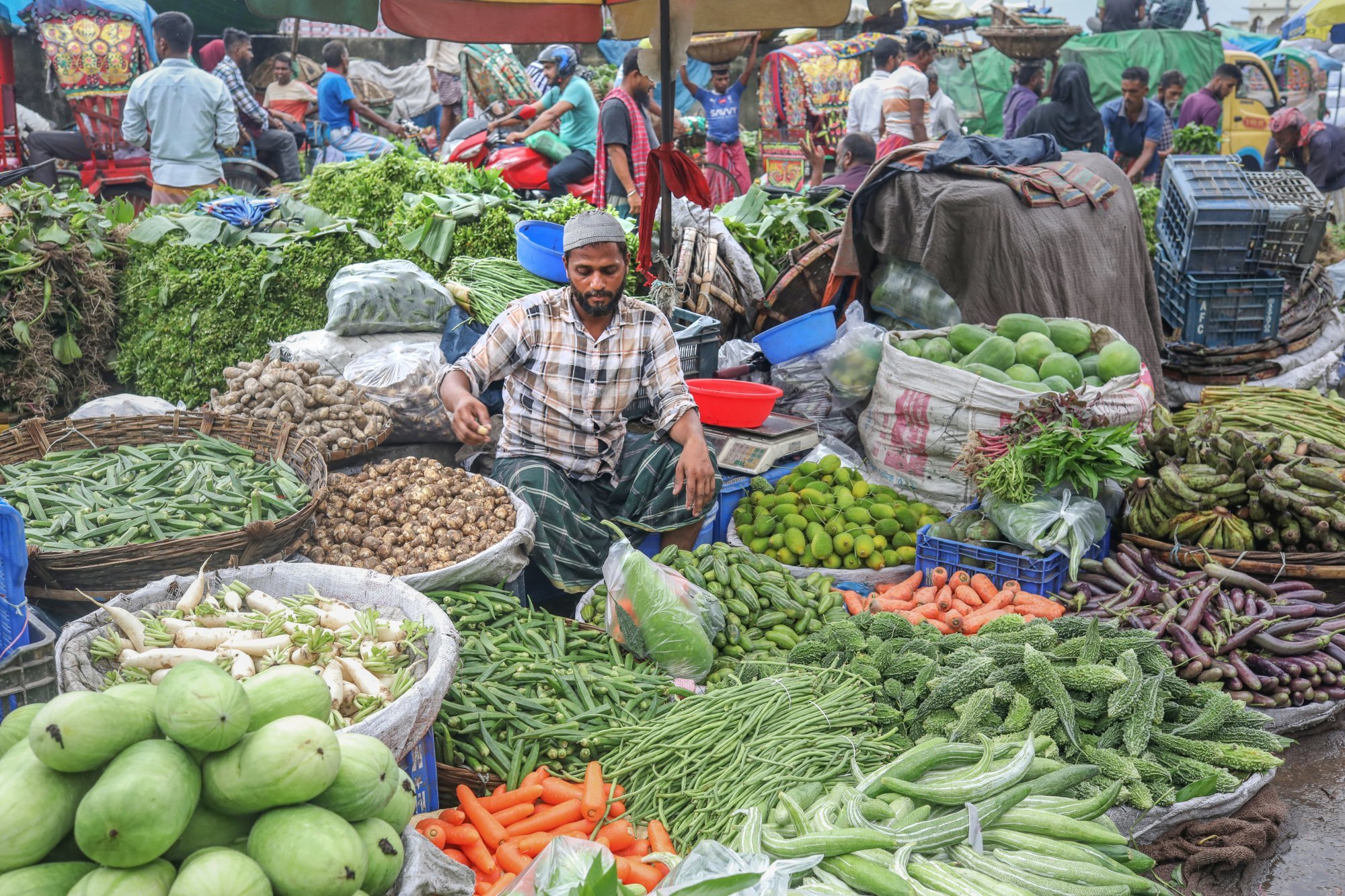 A vendor waits for customers at the vegetable wholesale market in the Shyam Bazar area in Dhaka, Bangladesh, on Monday. Momentum for reform has stalled amid high inflation and youth unemployment. Photo: EPA