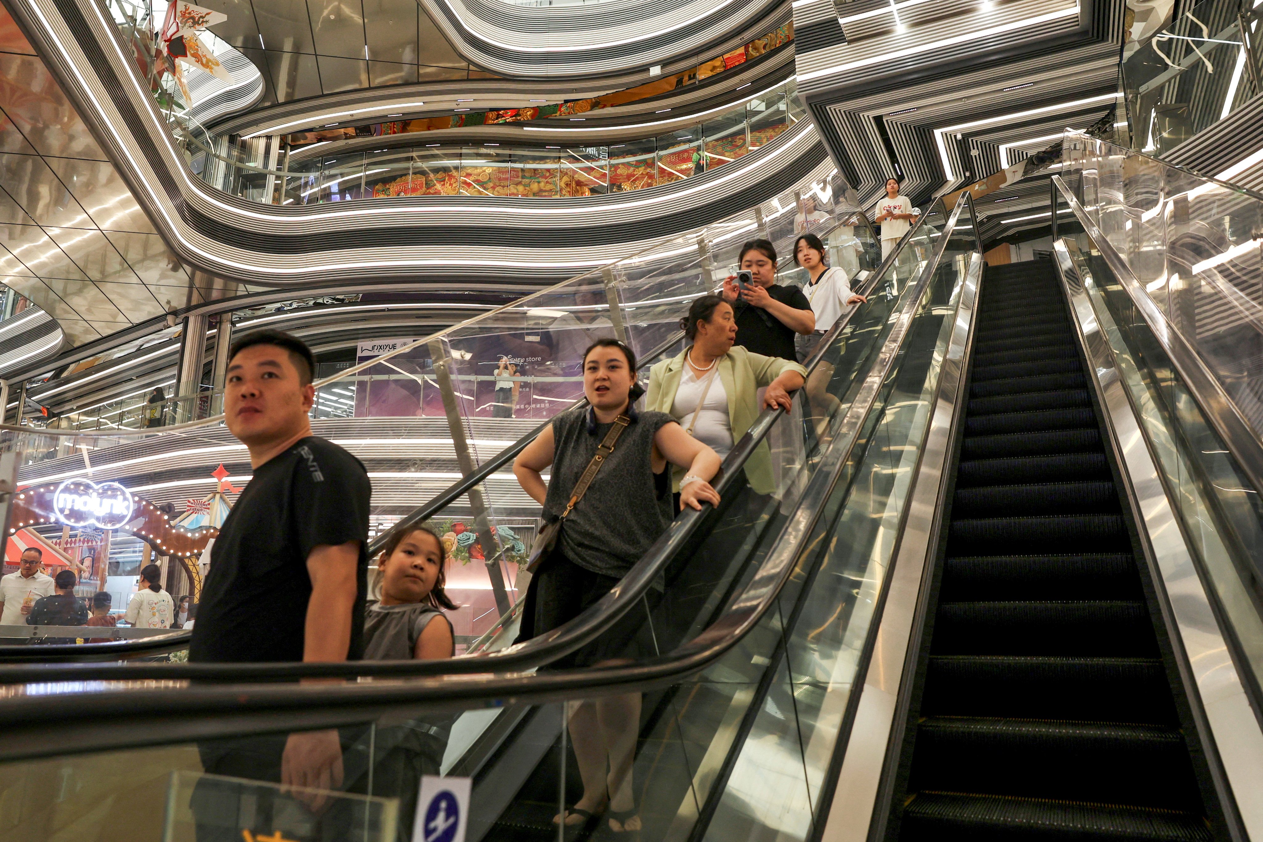 Shoppers at a mall in Beijing in July. The PBOC aims to boost coordination with fiscal policies to support sectors including consumption, small and micro businesses, and exports. Photo: Reuters