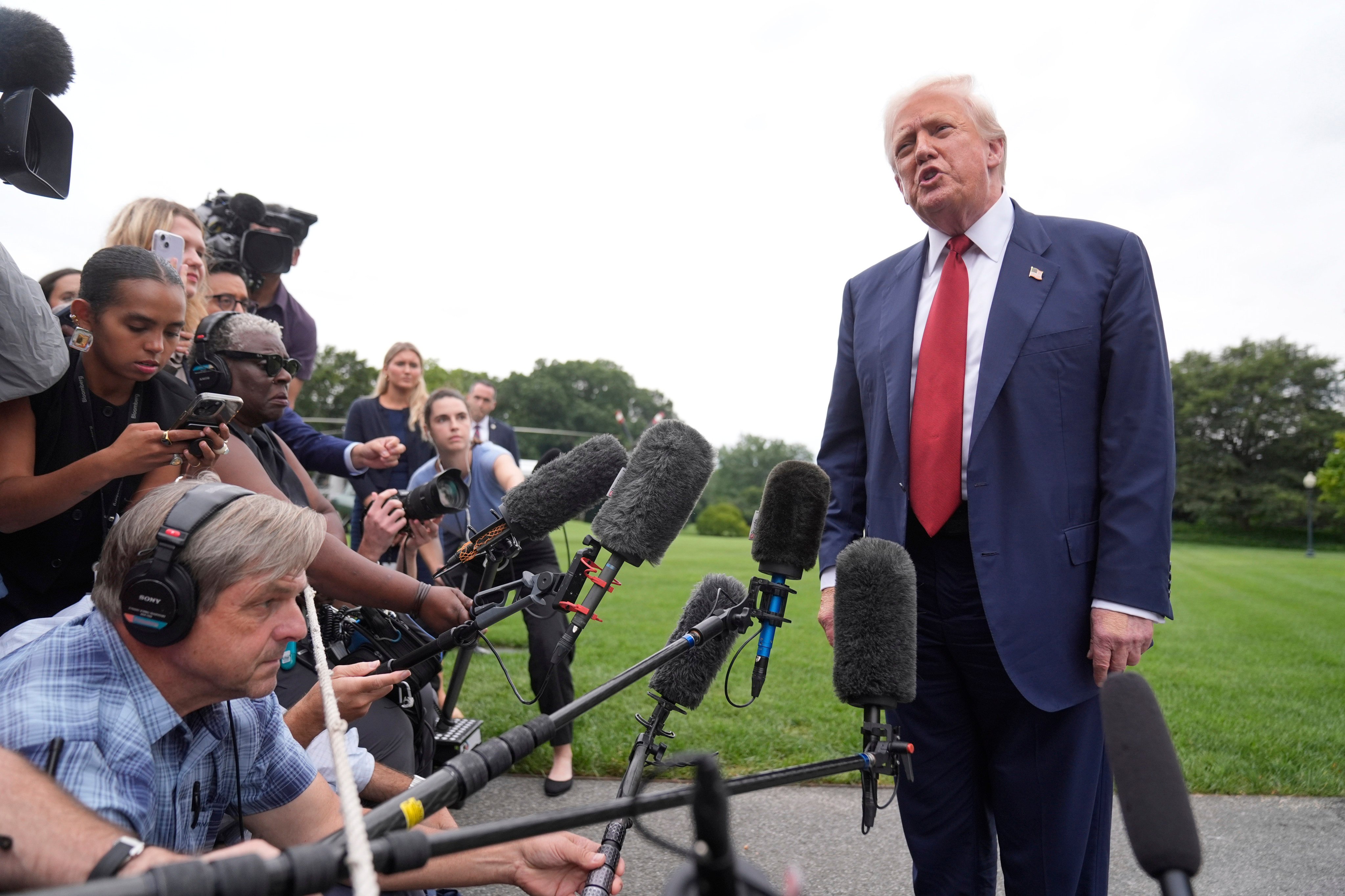 US President Donald Trump talks to reporters on the South Lawn of the White House Friday. Photo: AP