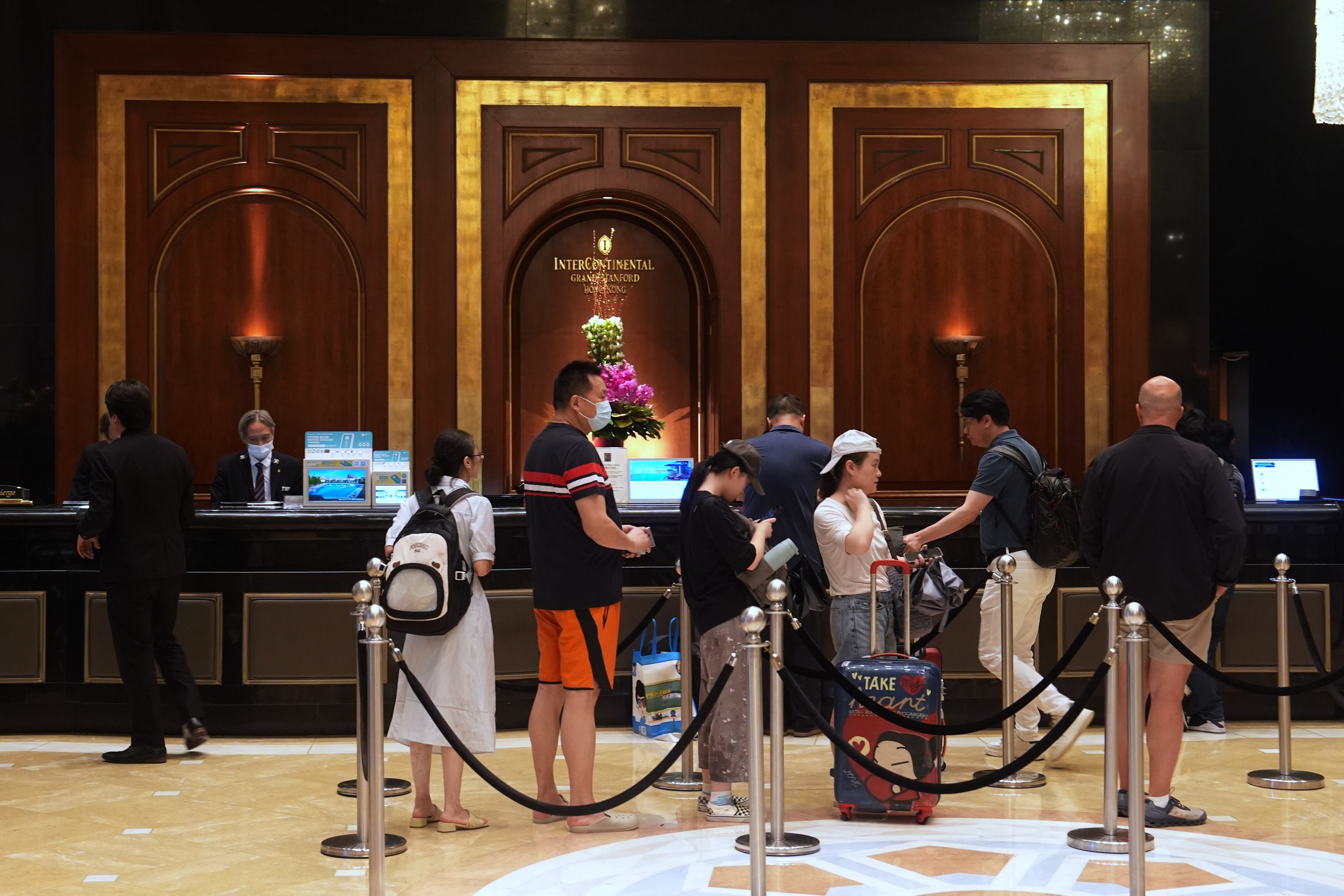 Guests wait to check in at a hotel in Tsim Sha Tsui. Photo: Elson Li
