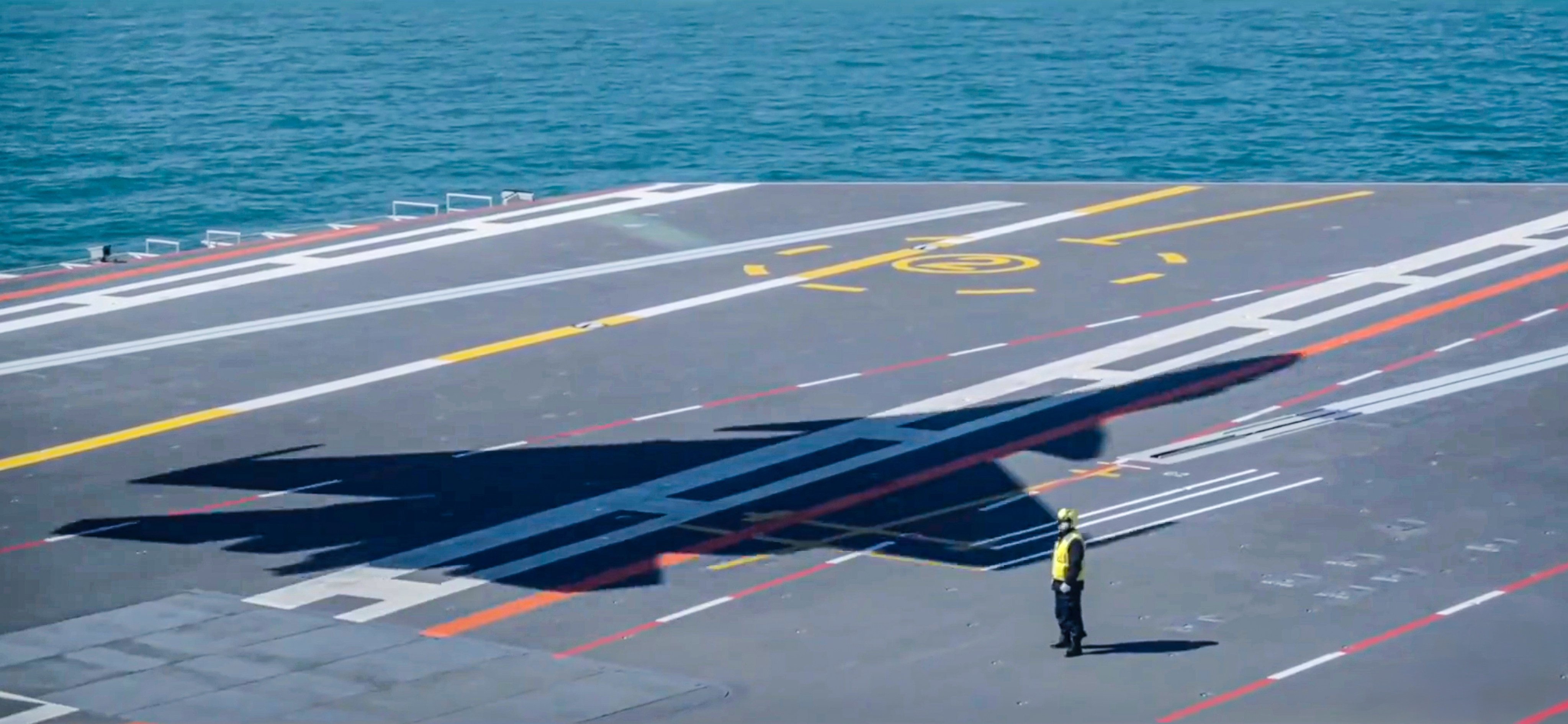 A shadow cast on the Fujian’s deck by an airborne J-15T ends a short segment aired as part of five-episode CCTV military series Forging Ahead. Photo: CCTV
