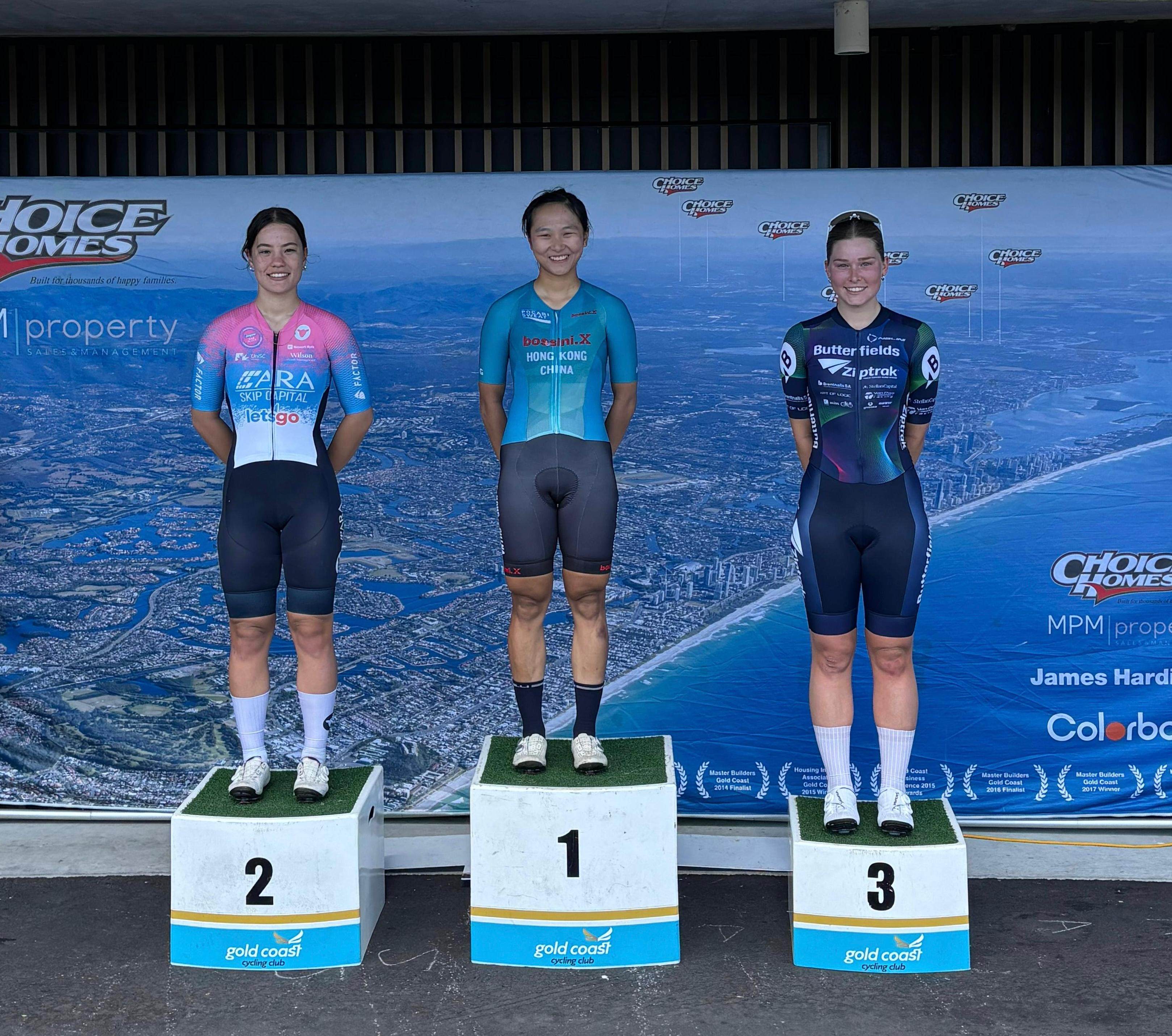 Ceci Lee (centre) on the top step of the criterium podium, between Australia’s silver and bronze medallists Amelie Sanders (left) and Sophie Sutton. Photo: Cycling Association of Hong Kong, China