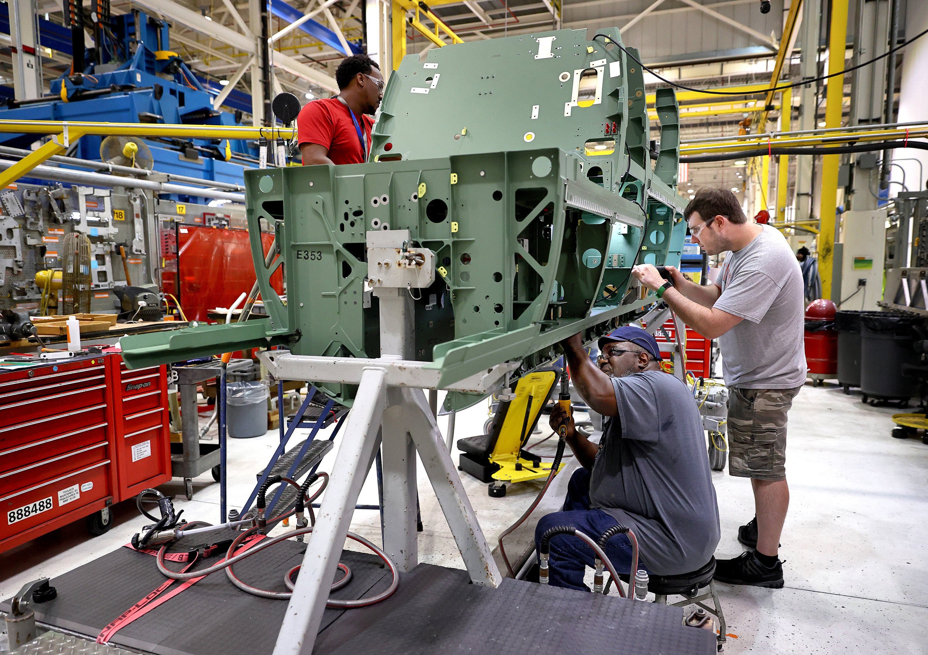 Workers assemble parts on a Boeing F/A-18 Super Hornet fighter jet at the St Louis assembly line. Photo: TNS