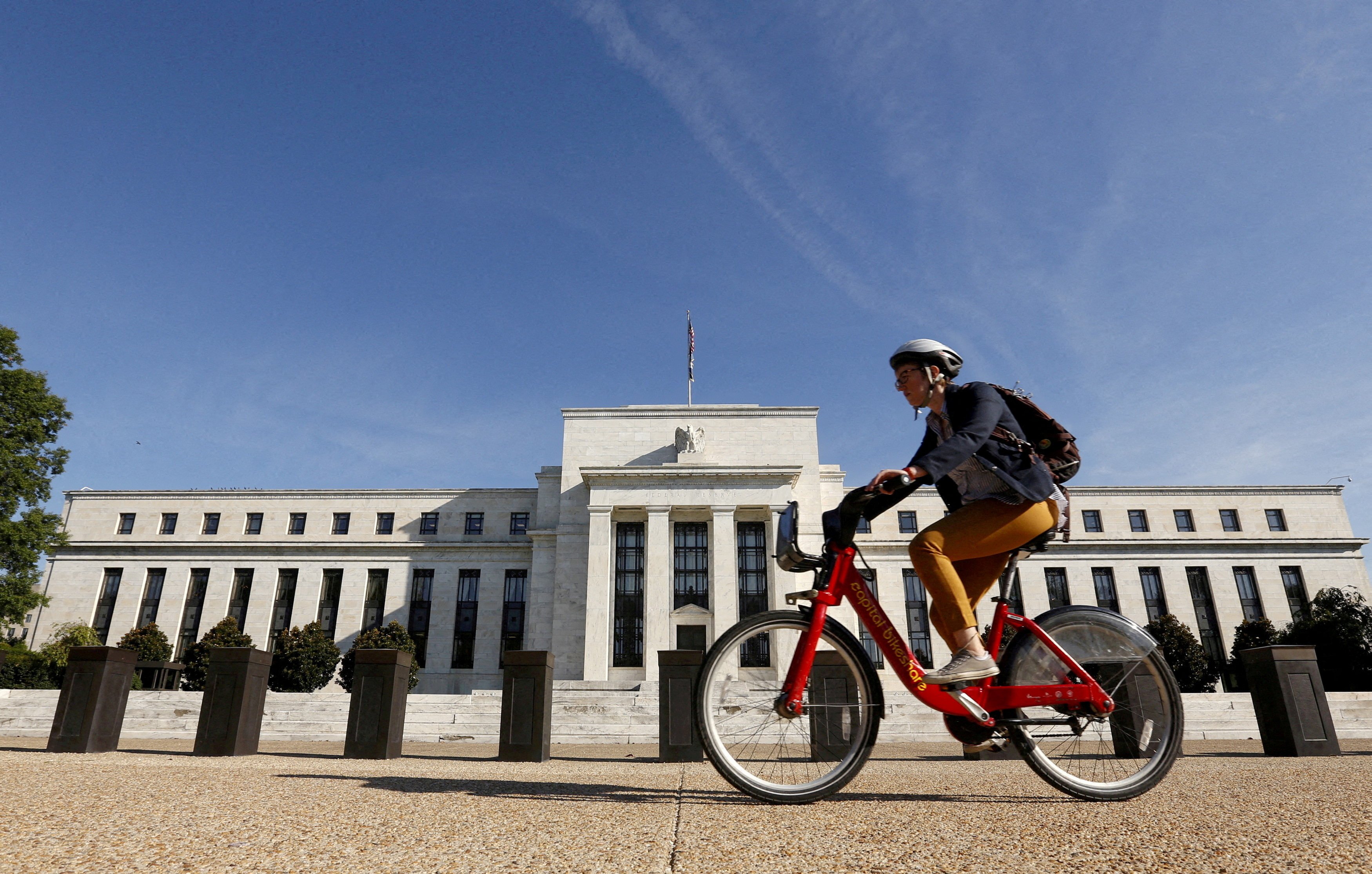 A cyclist passes the Federal Reserve headquarters in Washington. Photo: Reuters