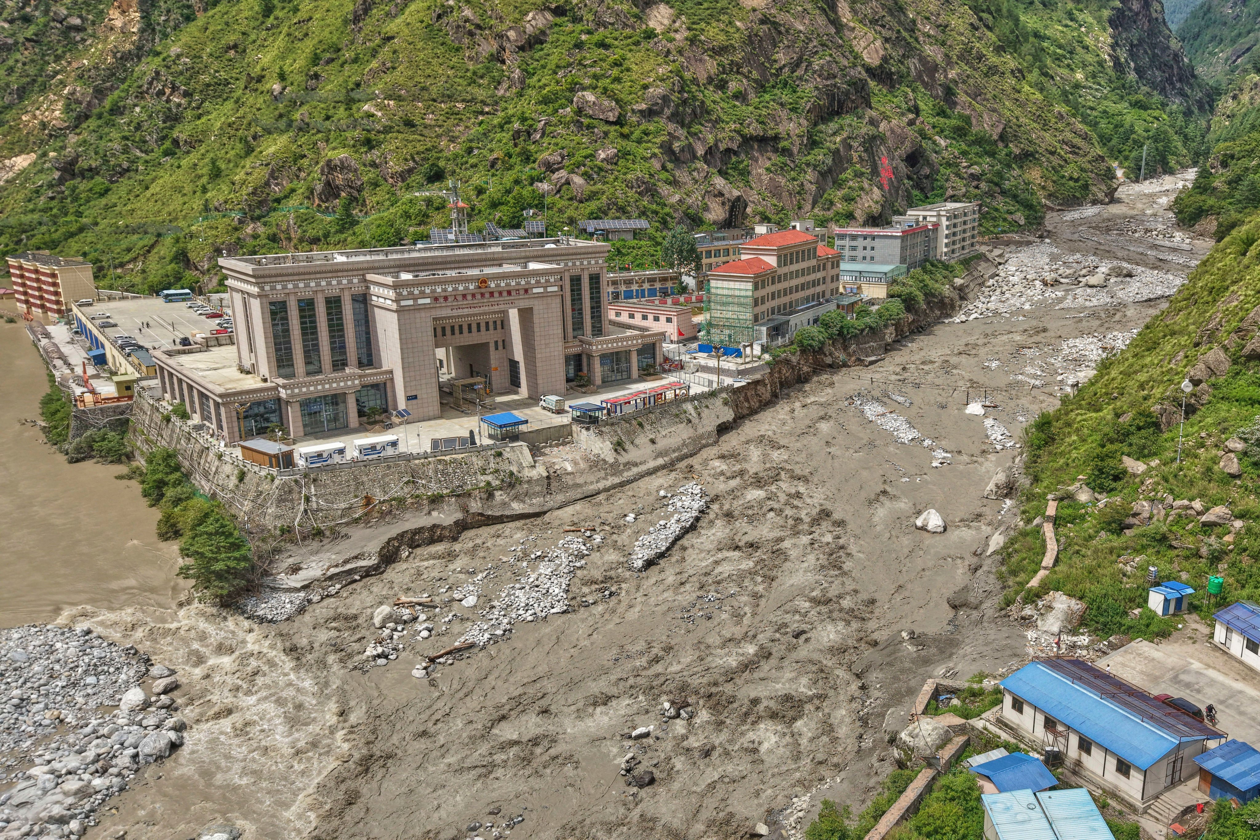 China (left) and Nepal (right) are seen divided after the Friendship Bridge, a key connector over the Bhotekoshi River in Rasuwagadi, was swept away by floods on July 8. Photo: AP