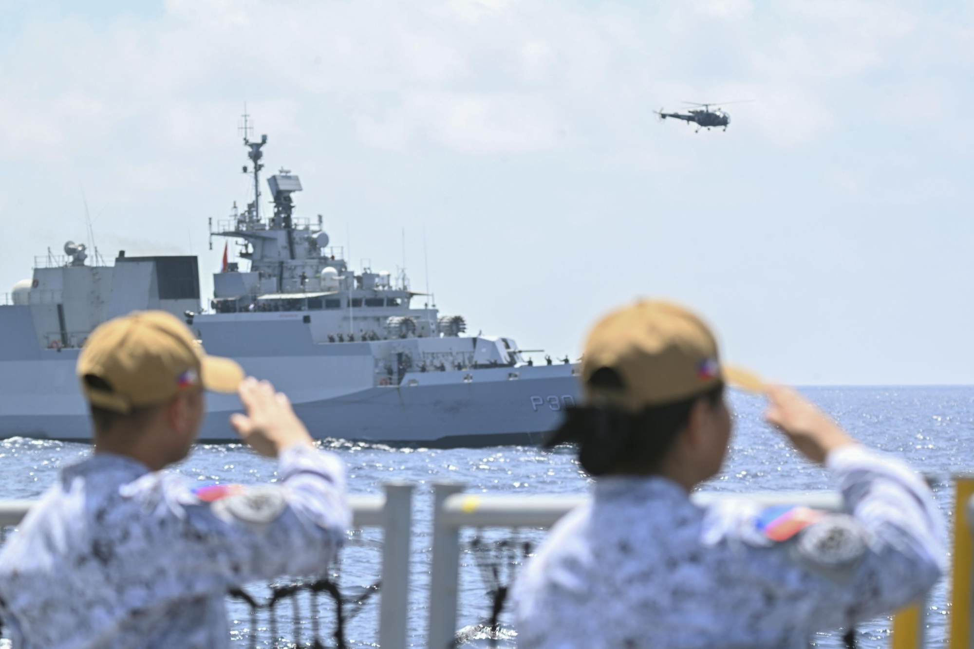 Philippine Navy personnel salute an Indian Navy vessel in the South China Sea, off the west coast of the Philippines, on Monday, during their first naval exercise with India. Photo: Kyodo Philippine Navy personnel salute an Indian Navy vessel in the South China Sea, off the west coast of the Philippines, on Monday, during their first naval exercise with India. Photo: Kyodo