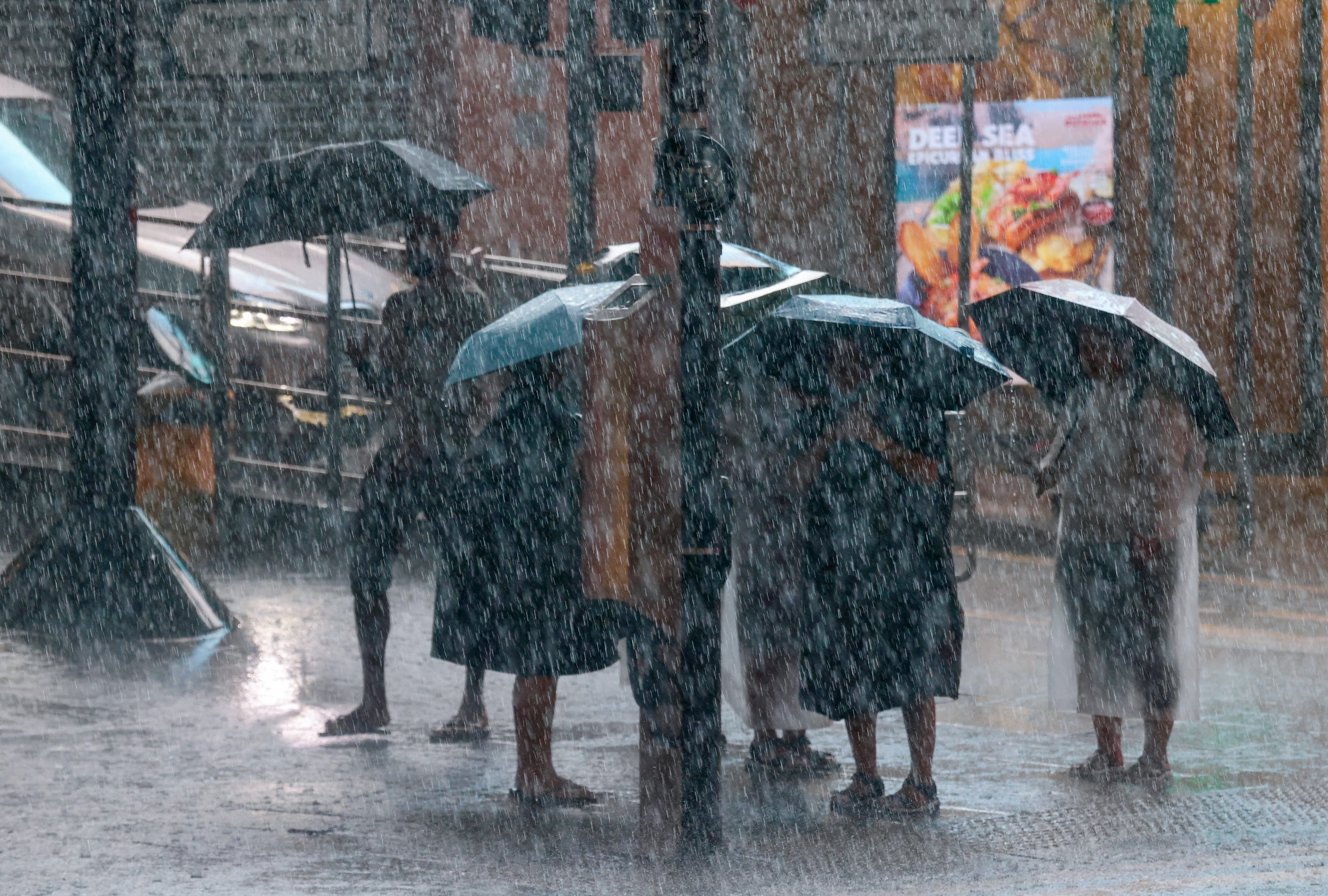 People brave the downpour during the black rainstorm warning, which is expected to last until 5.05pm. Photo: Jonathan Wong
