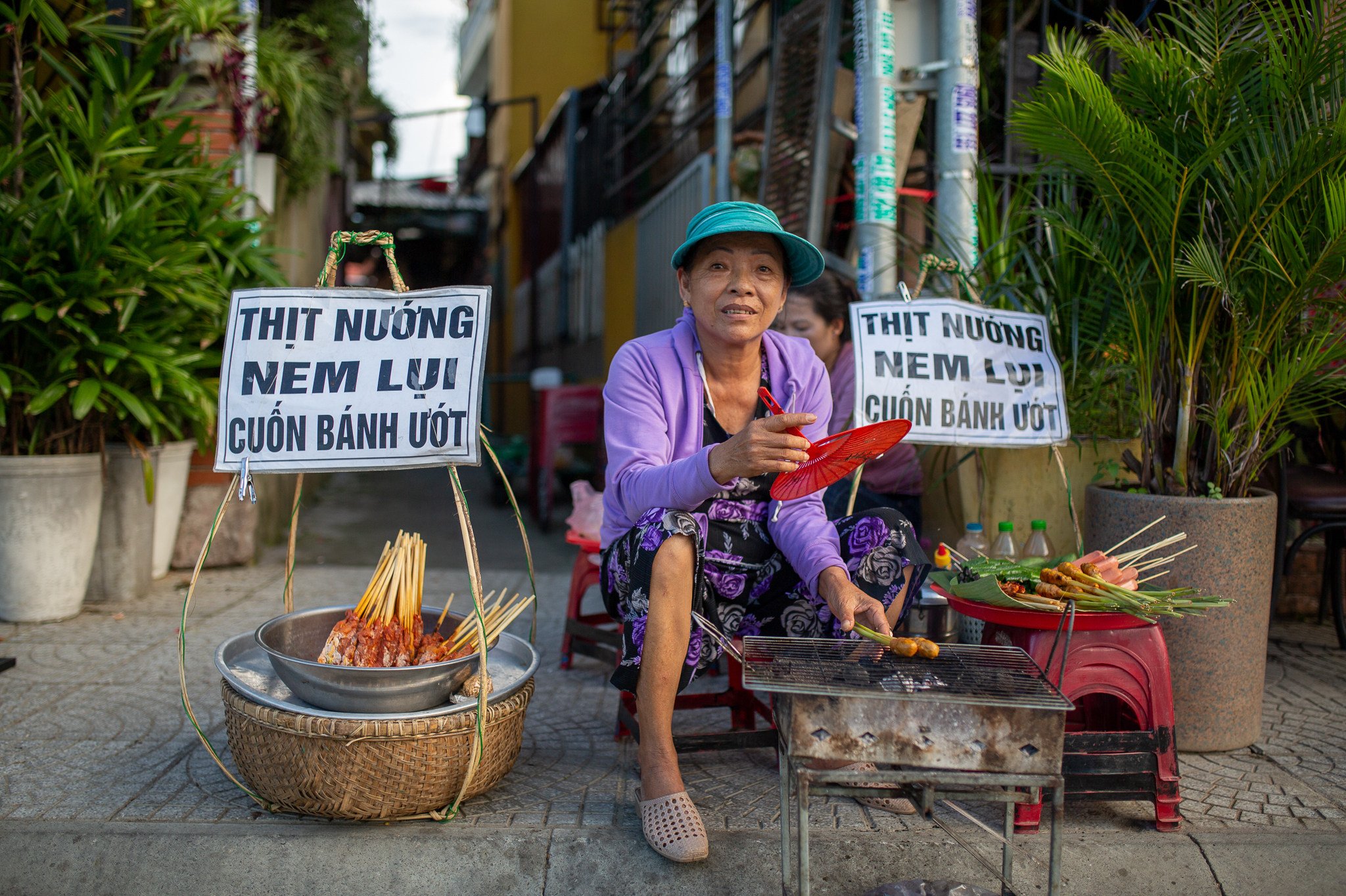 A street seller grills pork skewers beside a river walkway in Hoi An. African swine fever threatens to disrupt pork supply in Vietnam. Photo: Getty Images