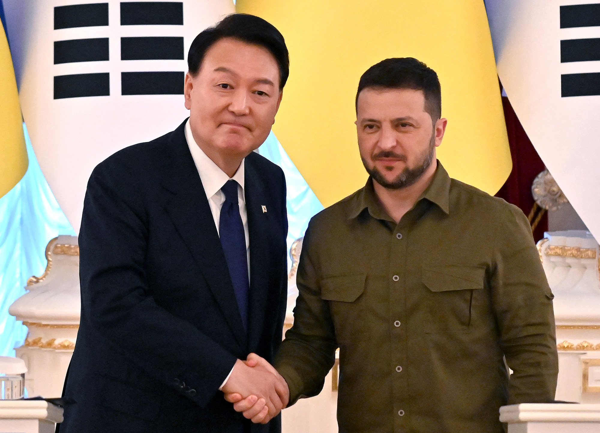 Yoon Suk-yeol shakes hands with his Ukrainian counterpart Volodymyr Zelensky (right) following talks in Kyiv in July 2023. Photo: AFP/Getty Images/TNS Yoon Suk-yeol shakes hands with his Ukrainian counterpart Volodymyr Zelensky (right) following talks in Kyiv in July 2023. Photo: AFP/Getty Images/TNS