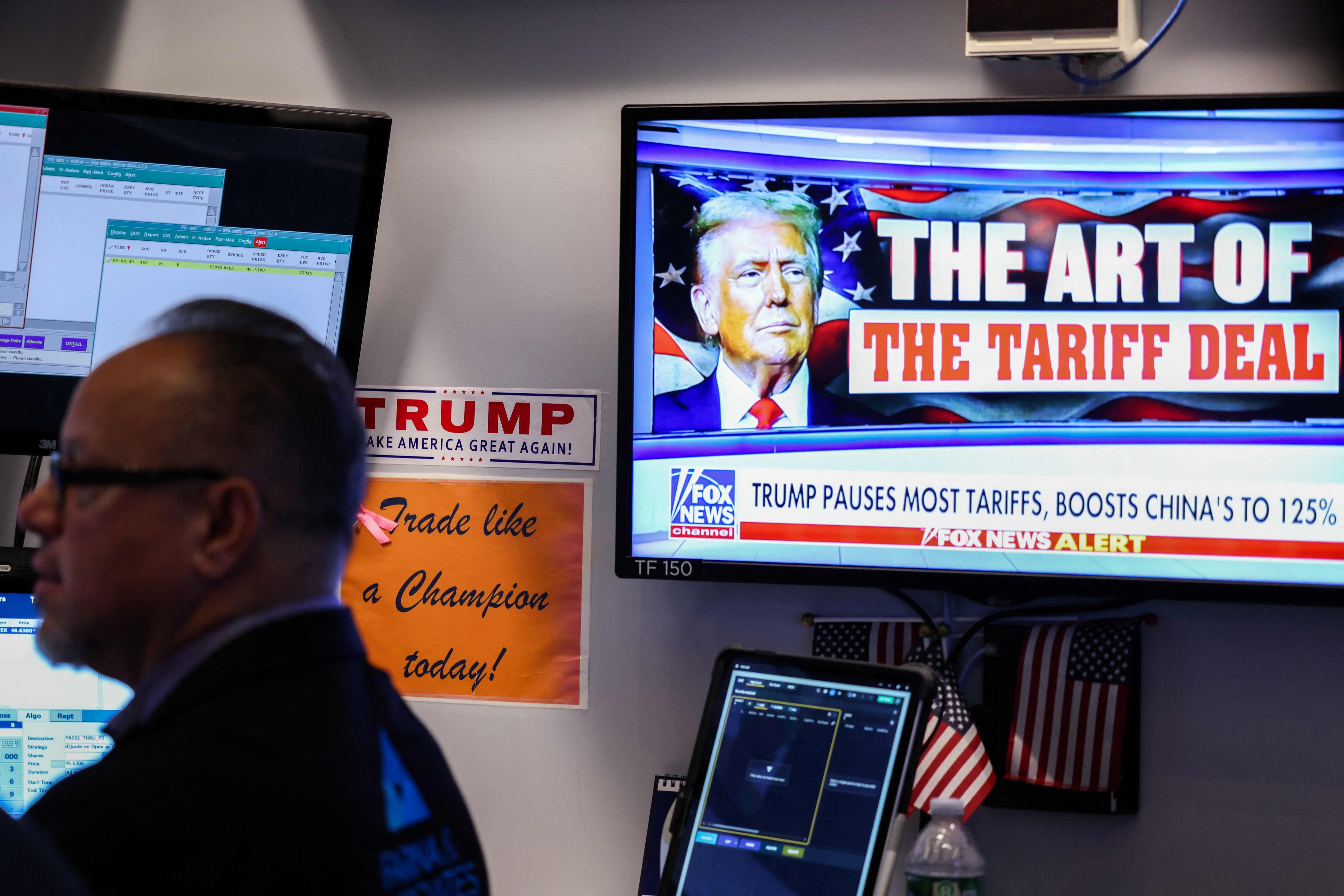 A television screen shows news about US President Donald Trump’s trade and tariff policies, on the floor of the New York Stock Exchange (NYSE) at the opening bell on April 10, 2025, in New York City. Wall Street stocks opened decisively lower Thursday, giving back a fraction of the gains from the prior session’s surge after President Donald Trump backed down on many of his trade tariffs. (Photo by CHARLY TRIBALLEAU / AFP)