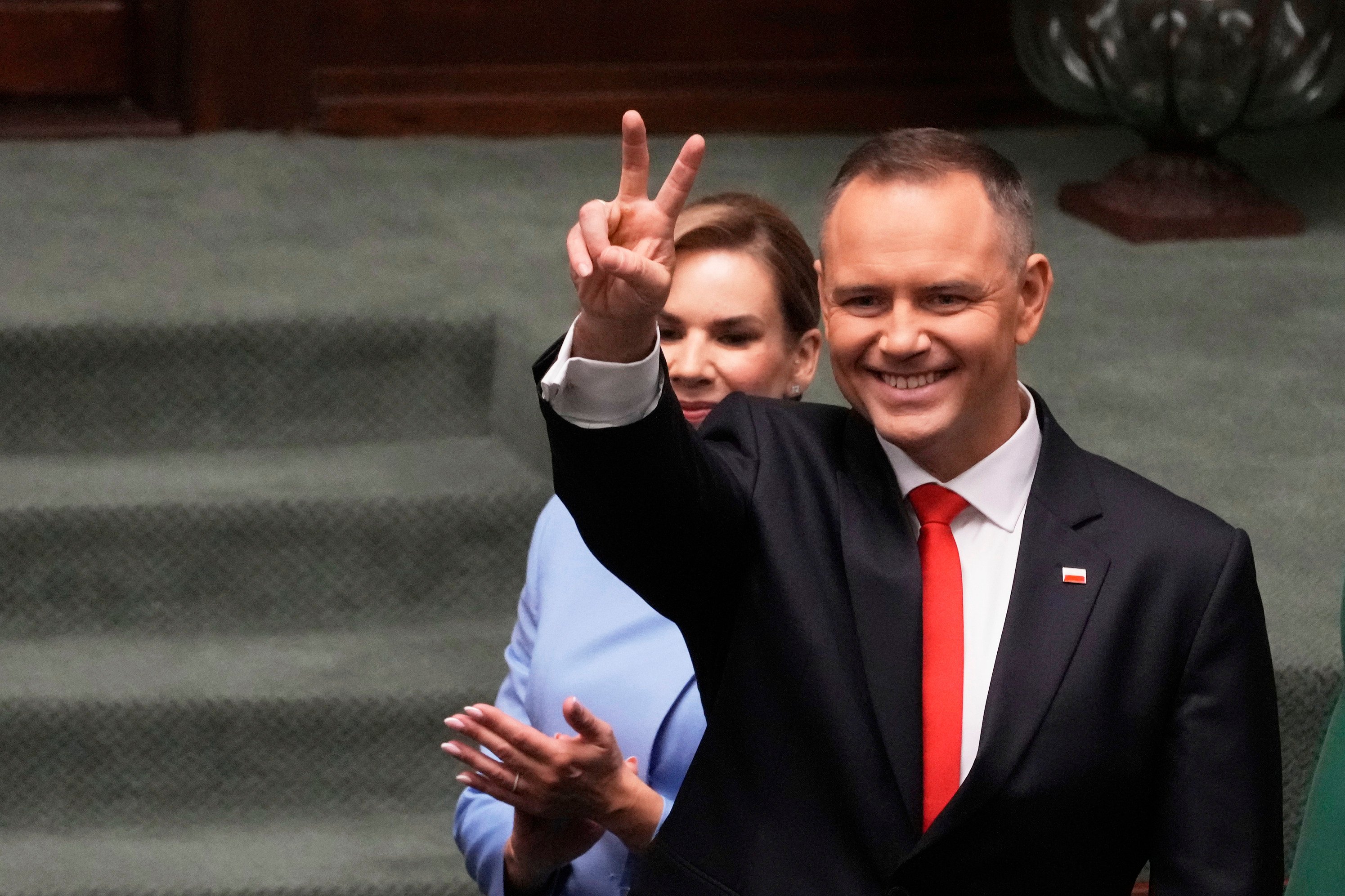 Poland’s new president Karol Nawrocki with his wife Marta Nawrocka shows a V-sign during the inauguration ceremony in Warsaw, Poland, on Wednesday. Photo: AP