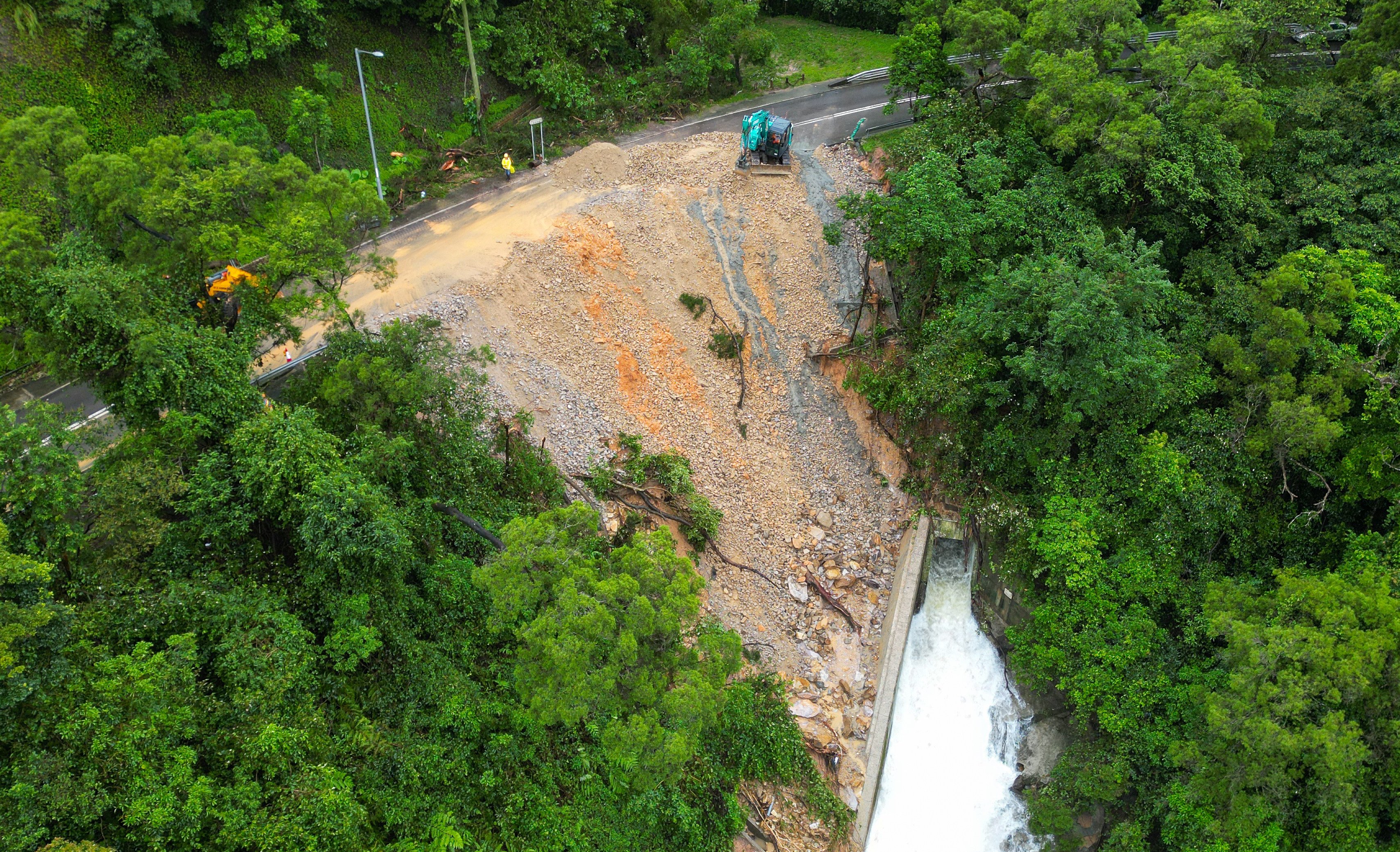 A section of Bride’s Pool Road in Tai Po was damaged during a landslide on Tuesday amid torrential rain. Photo: Sam Tsang