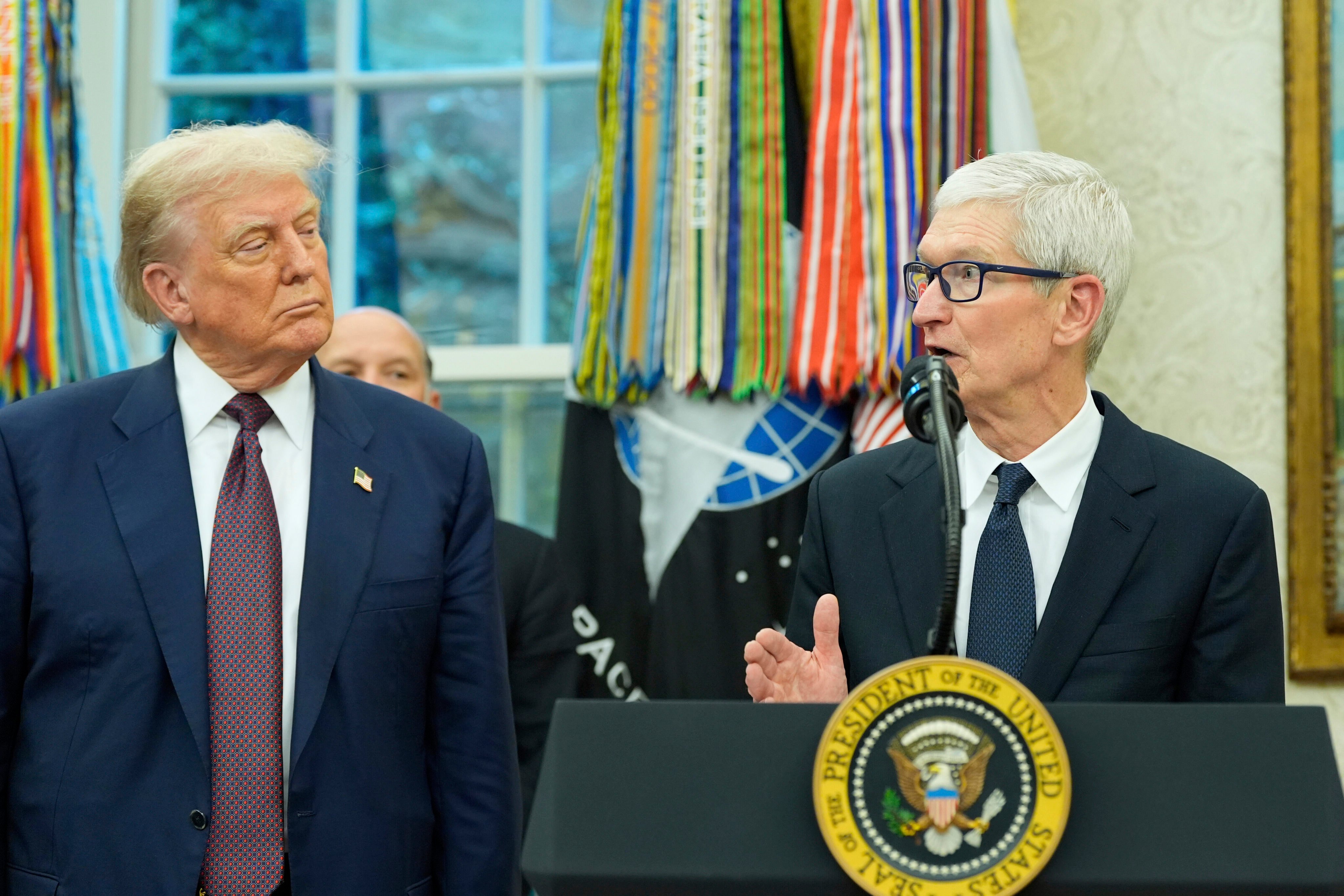 Apple CEO Tim Cook speaks as US President Donald Trump looks on in the Oval Office on Wednesday. Photo: AP