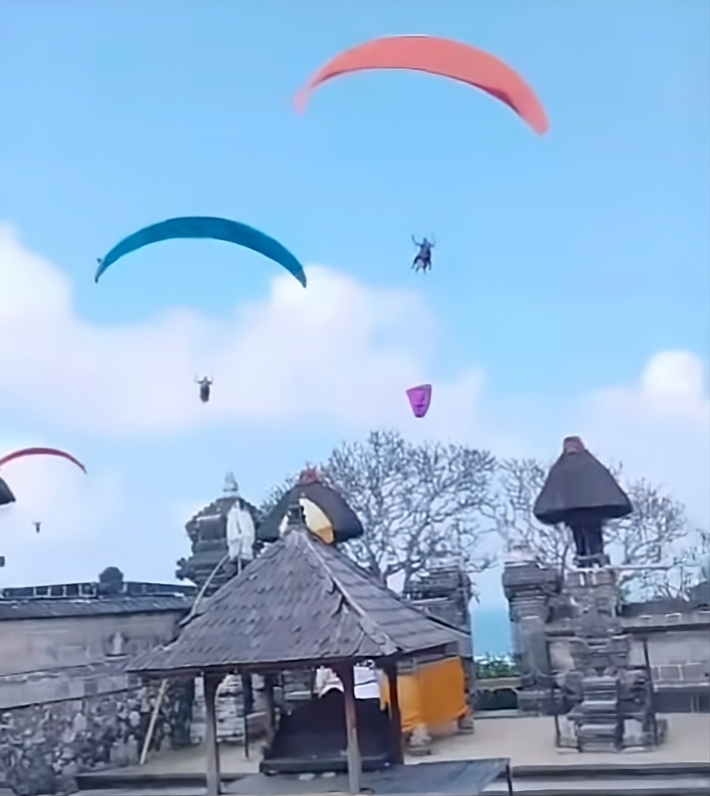 Footage showing paragliders flying near Pura Gunung Payung Temple in Bali on Sunday. Photo: Instagram/niluhdjelantik