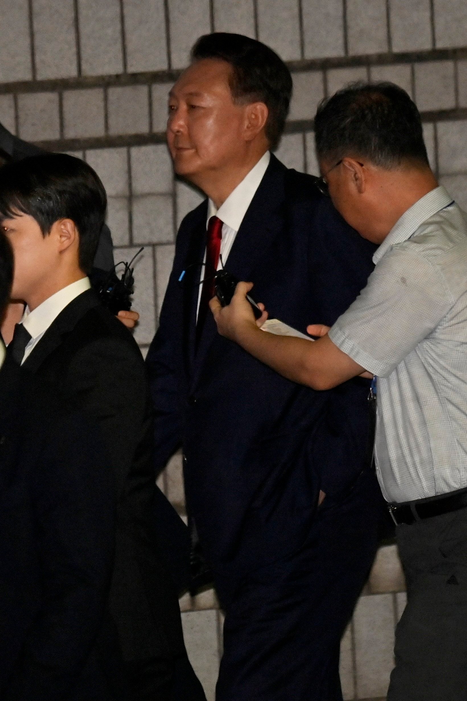 Former South Korean president Yoon Suk-yeol exits Seoul Central District Court after attending a hearing last month to review the legality of his detention. Photo: Yonhap/EPA