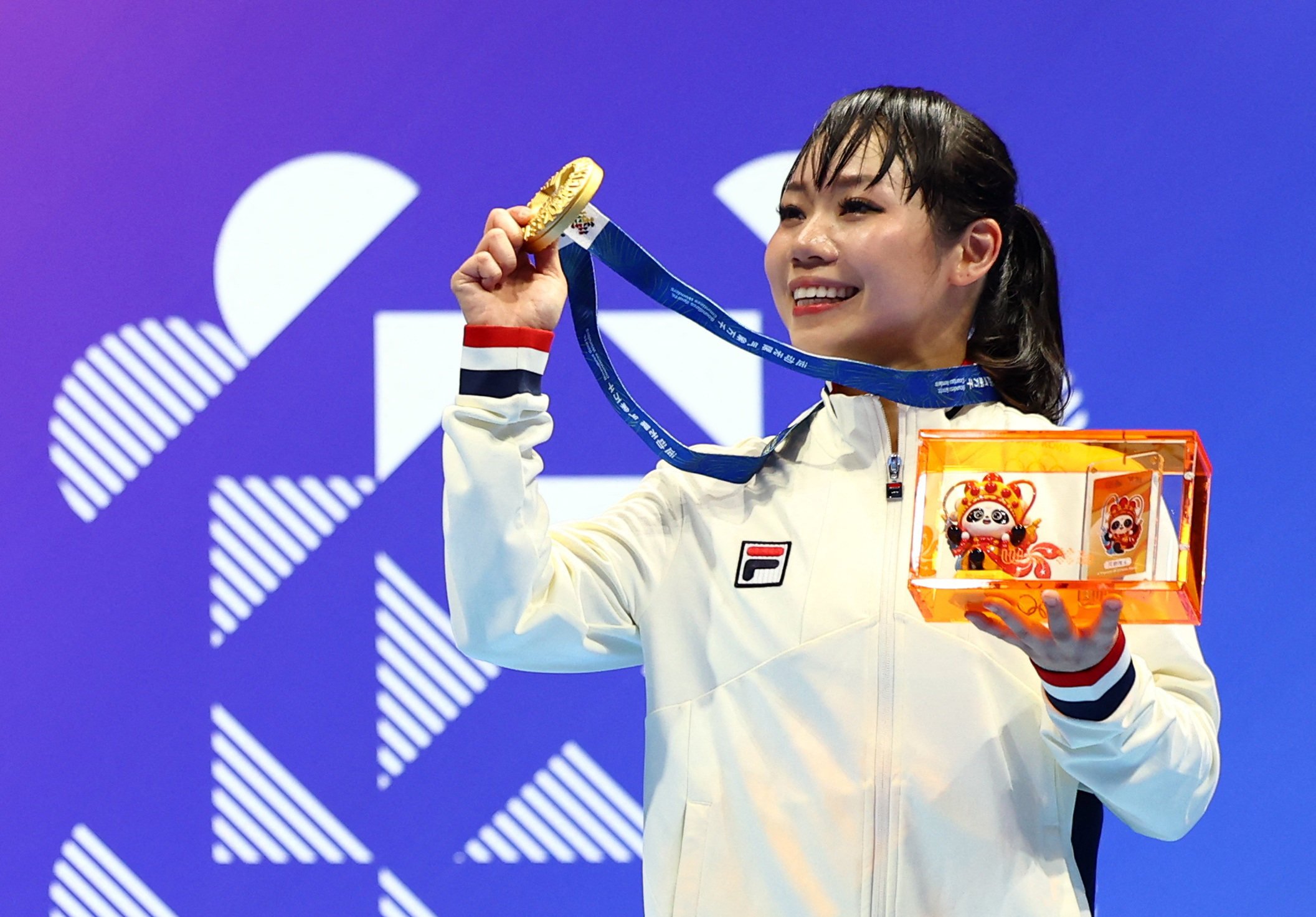 Grace Lau celebrates on the podium after winning Hong Kong’s first medal at the World Games in Chengdu in the karate kata event on Friday. Photo: Reuters