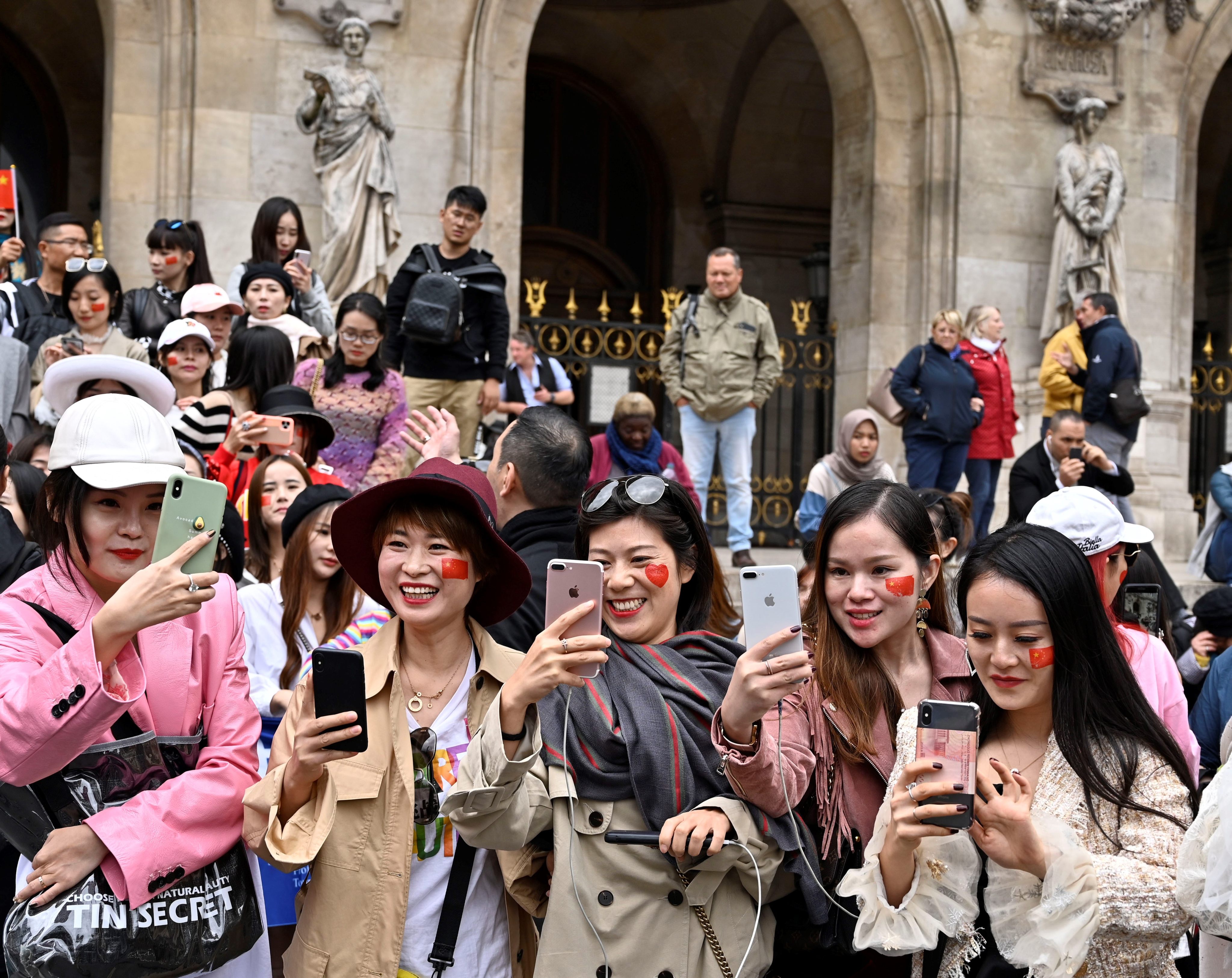 Chinese tourists take selfie in front of Opera Garnier in Paris, France on September 28, 2019. Photo: Anadolu Agency via Getty Images
