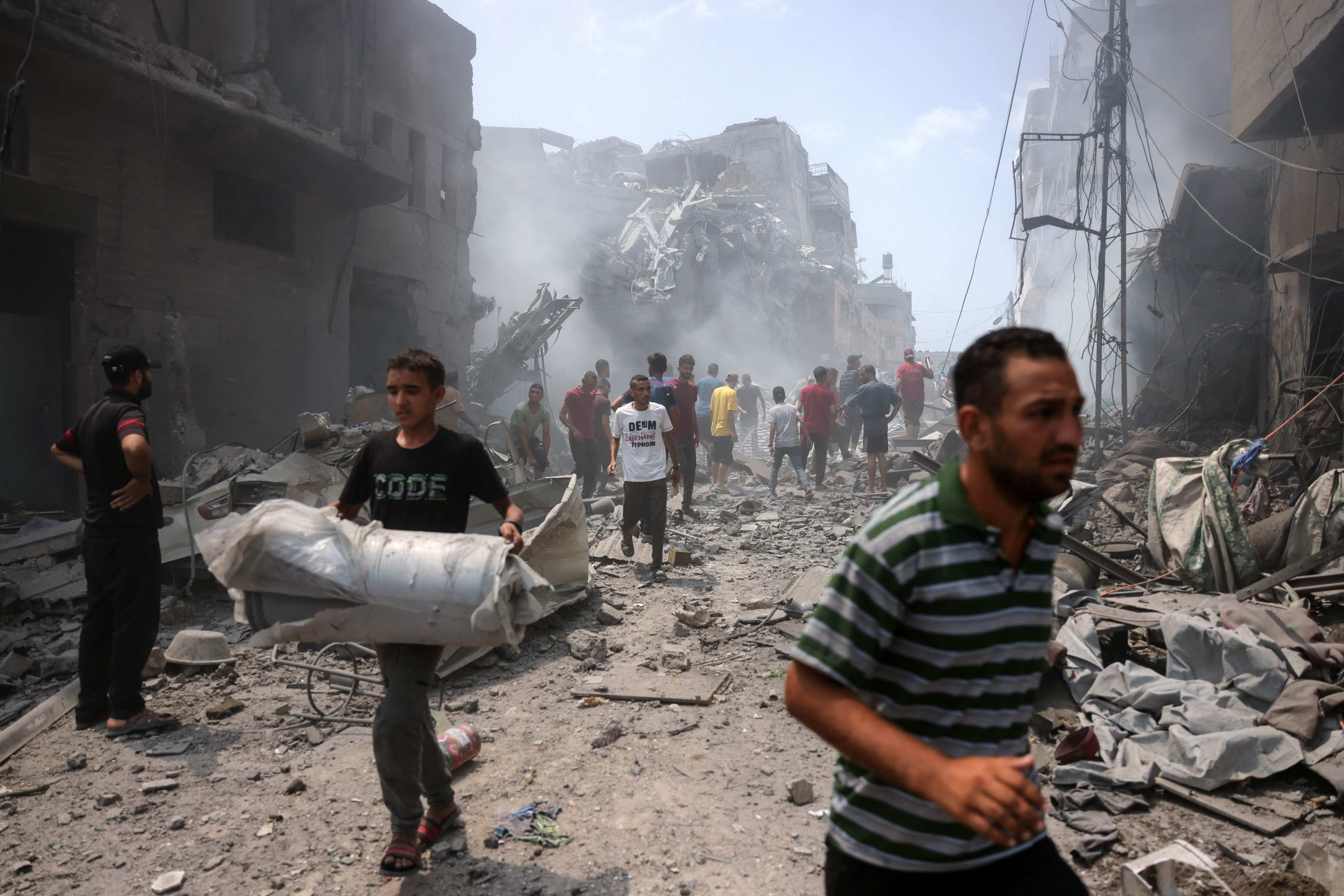 Palestinians check the devastation following an Israeli strike that hit Gaza City’s southern al-Zeitoun neighbourhood on Friday. Photo: AFP
