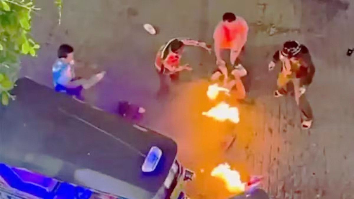 A screengrab from a social media video shows the two Malaysian tourists being set on fire in front of the Big C shopping centre in Bangkok. Photo: Handout