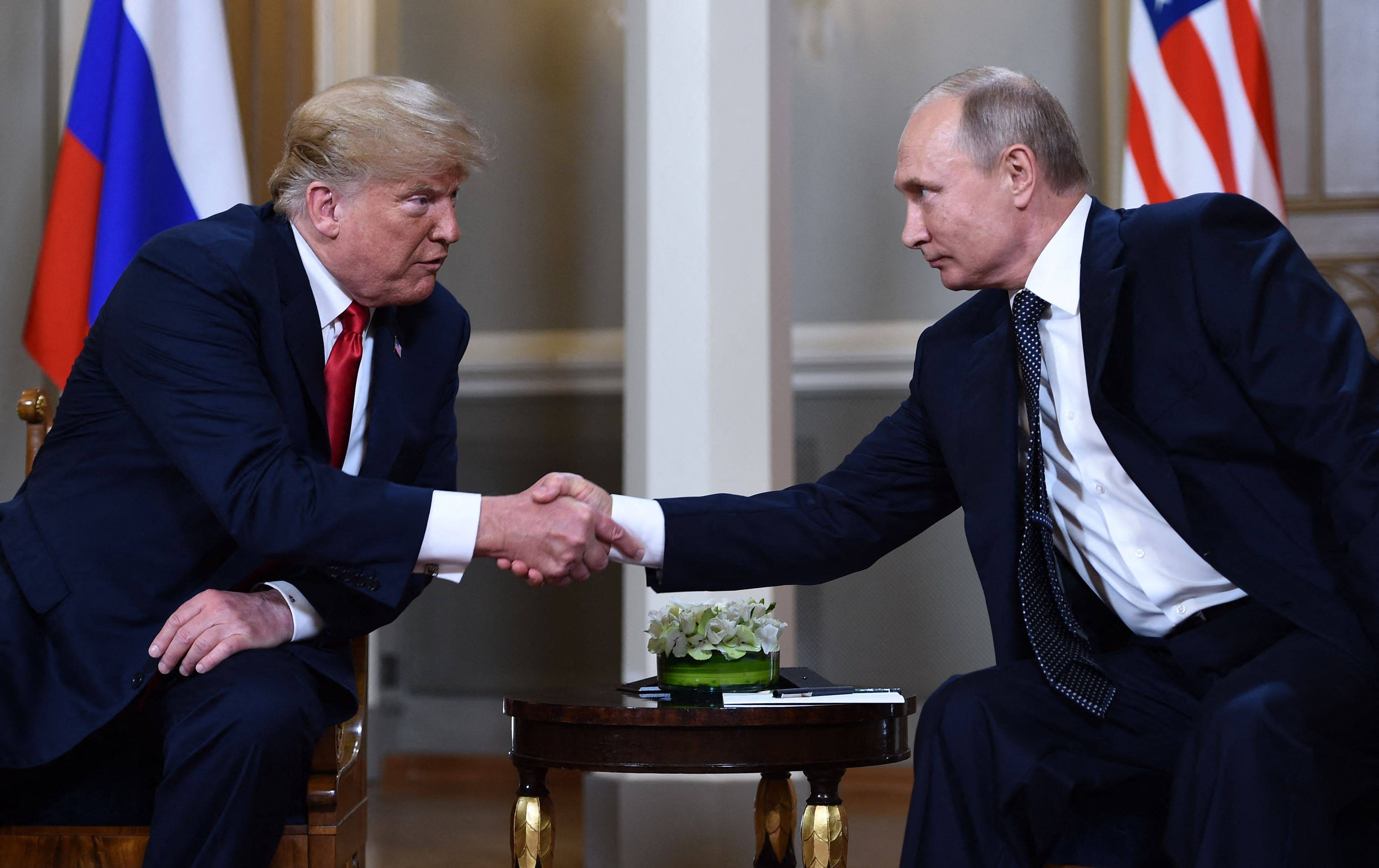 US President Donald Trump and Russian President Vladimir Putin shake hands before a meeting in Helsinki in July 2018. Photo: AFP