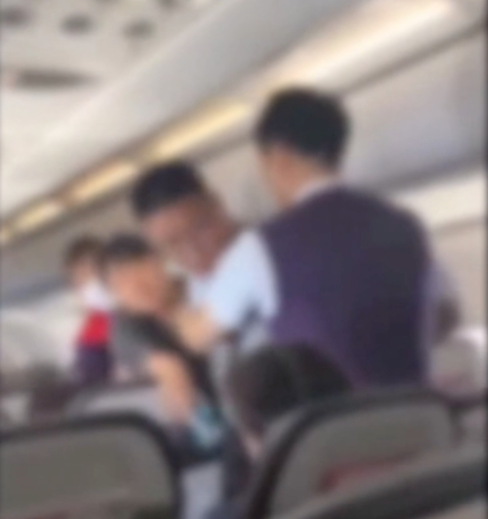 A Hong Kong Airlines cabin crew member steps in to stop passengers arguing. Photo: Handout A Hong Kong Airlines cabin crew member steps in to stop passengers arguing. Photo: Handout