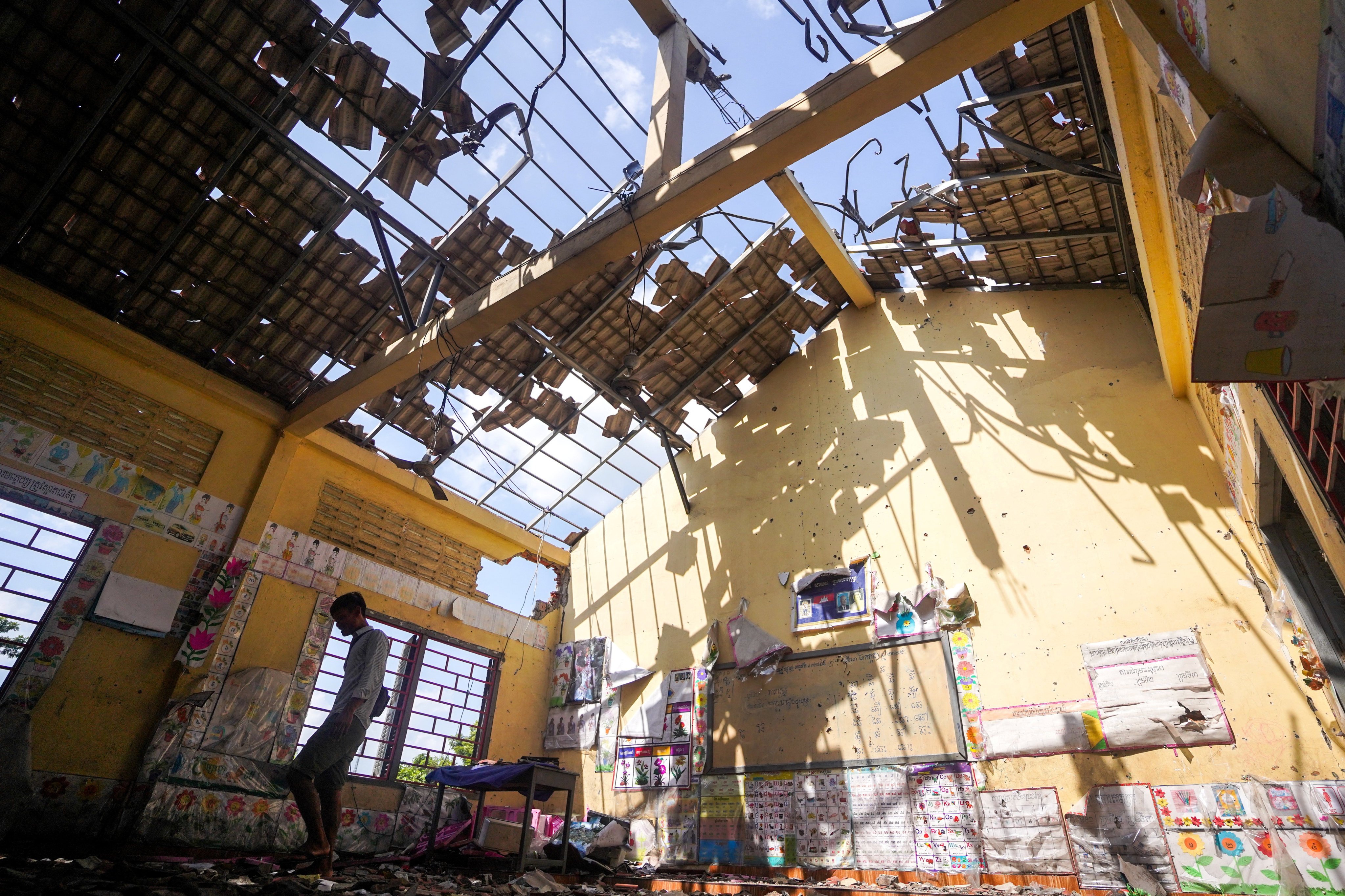 A man walks inside a building damaged by artillery along the Thailand-Cambodia border in Oddar Meanchey, Cambodia, on August 1. Photo: Reuters